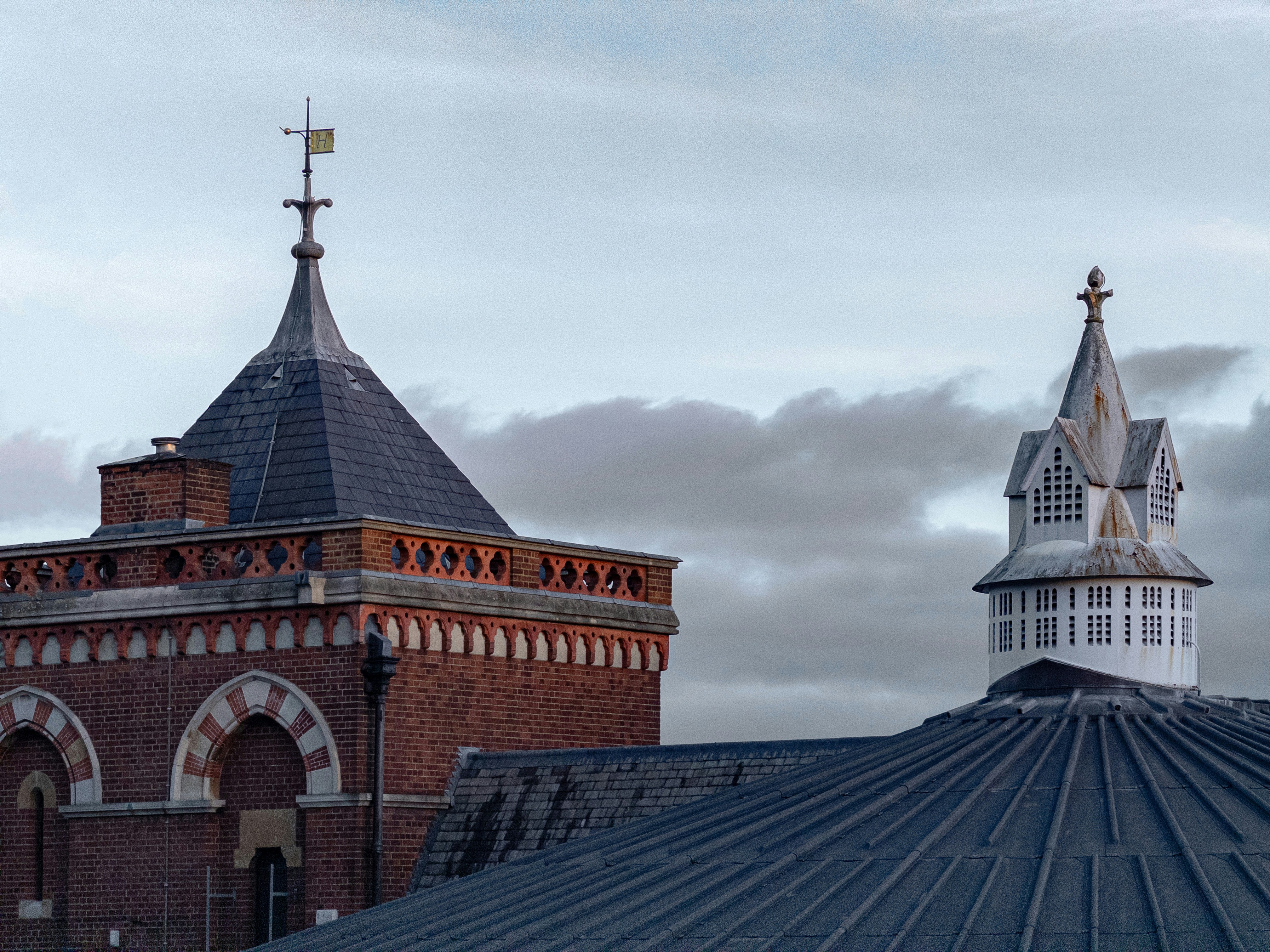 Two ornate towers against a cloudy sky
