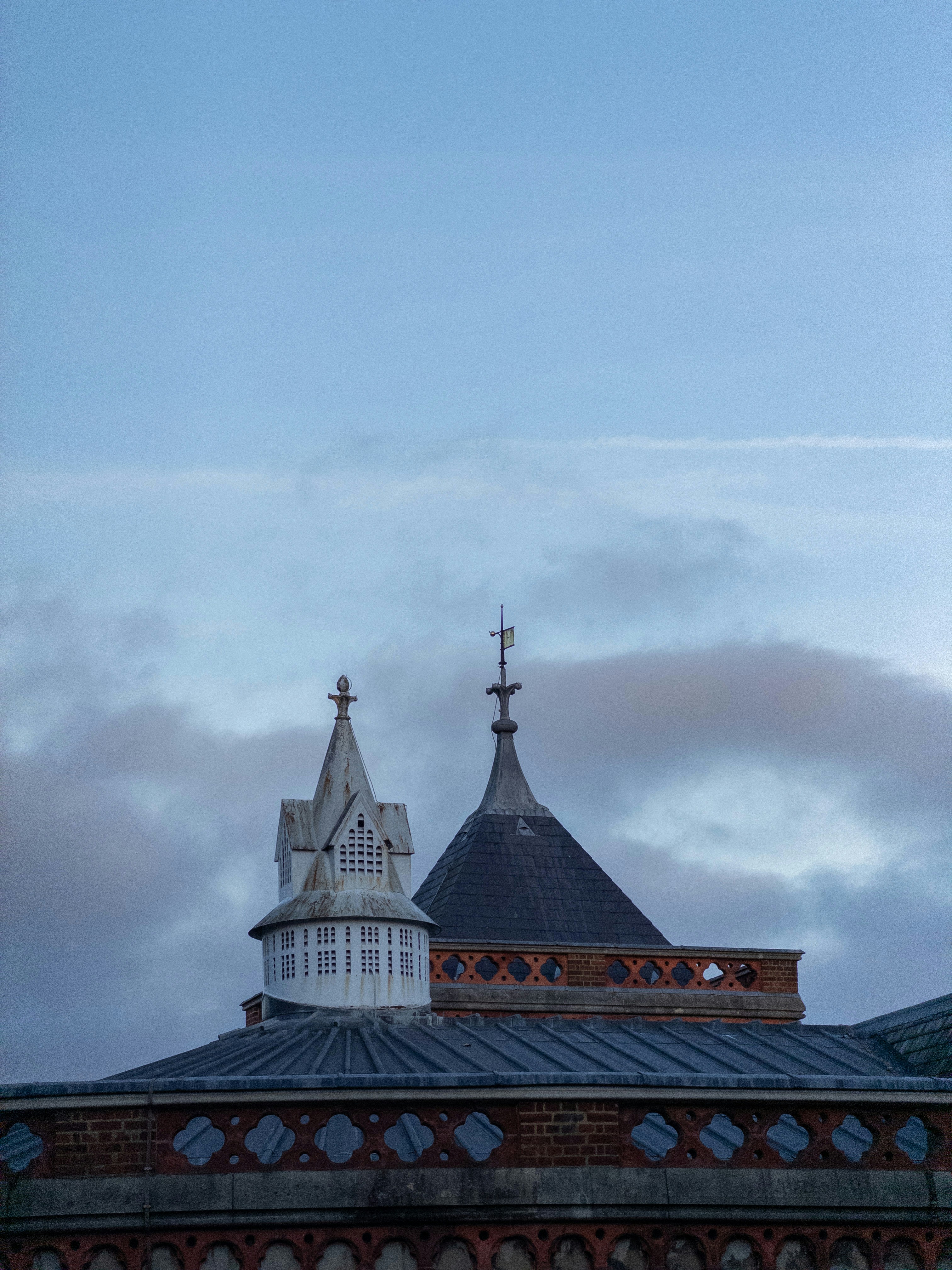 Towers and rooftops against a cloudy sky