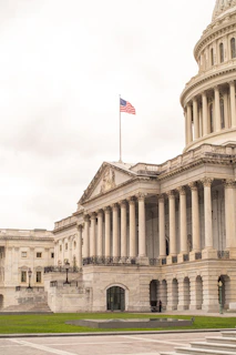 The united states capitol building with american flag flying.
