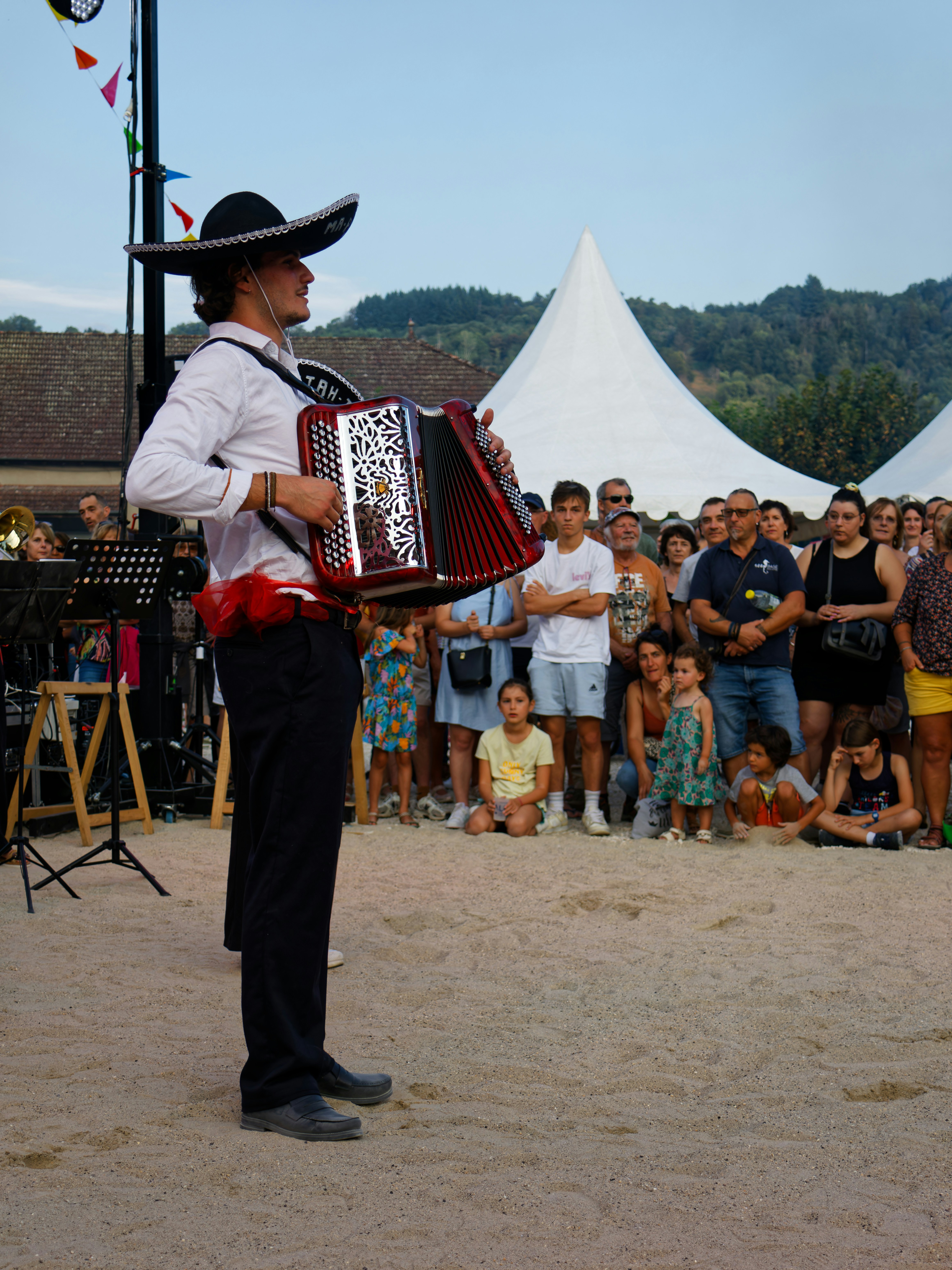 Man in sombrero plays accordion for crowd