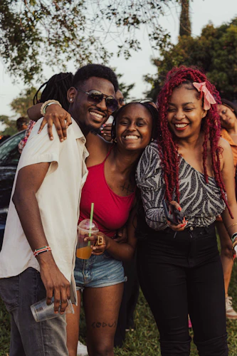 Three friends laughing outdoors