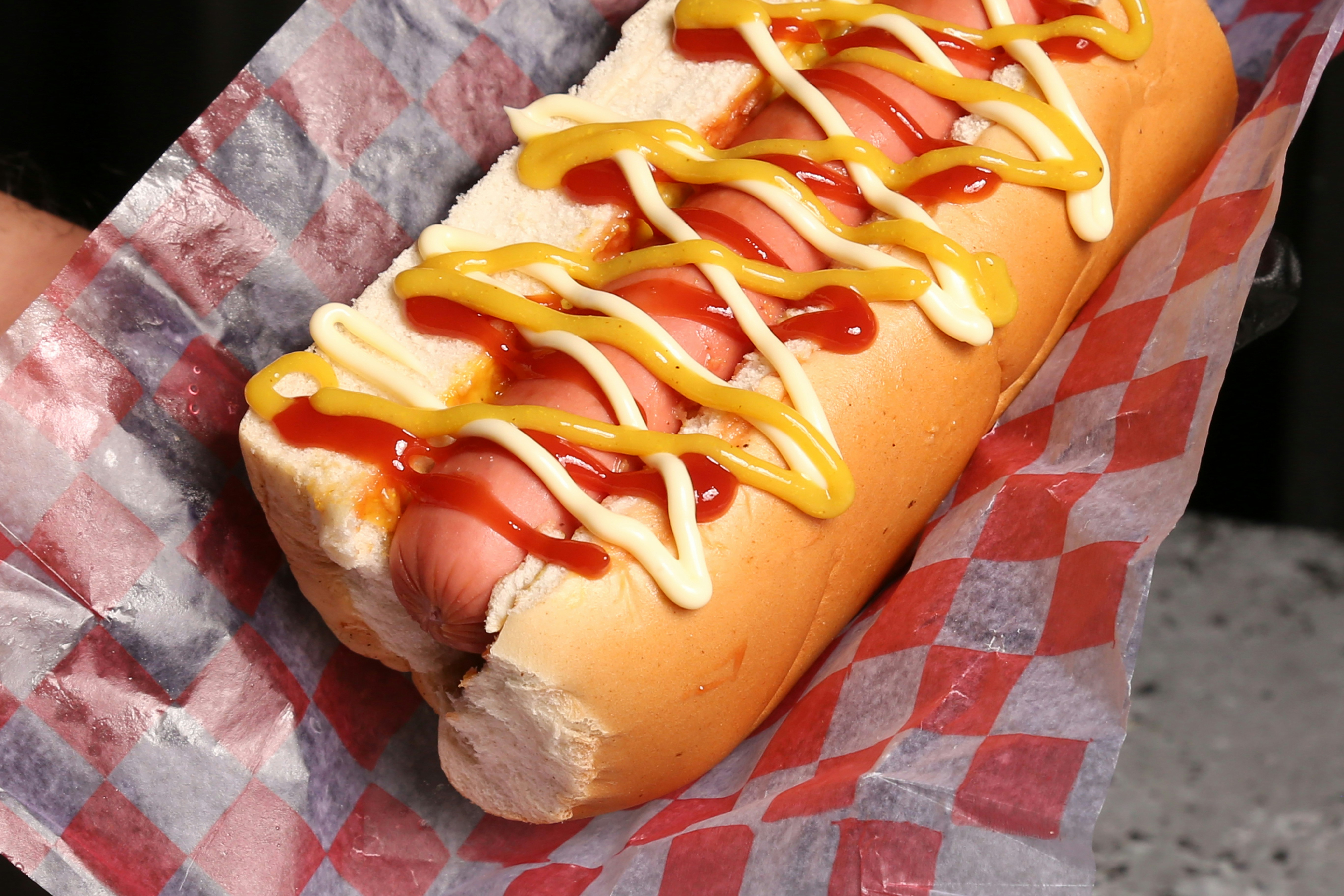 Hot dog with ketchup and mustard in bun