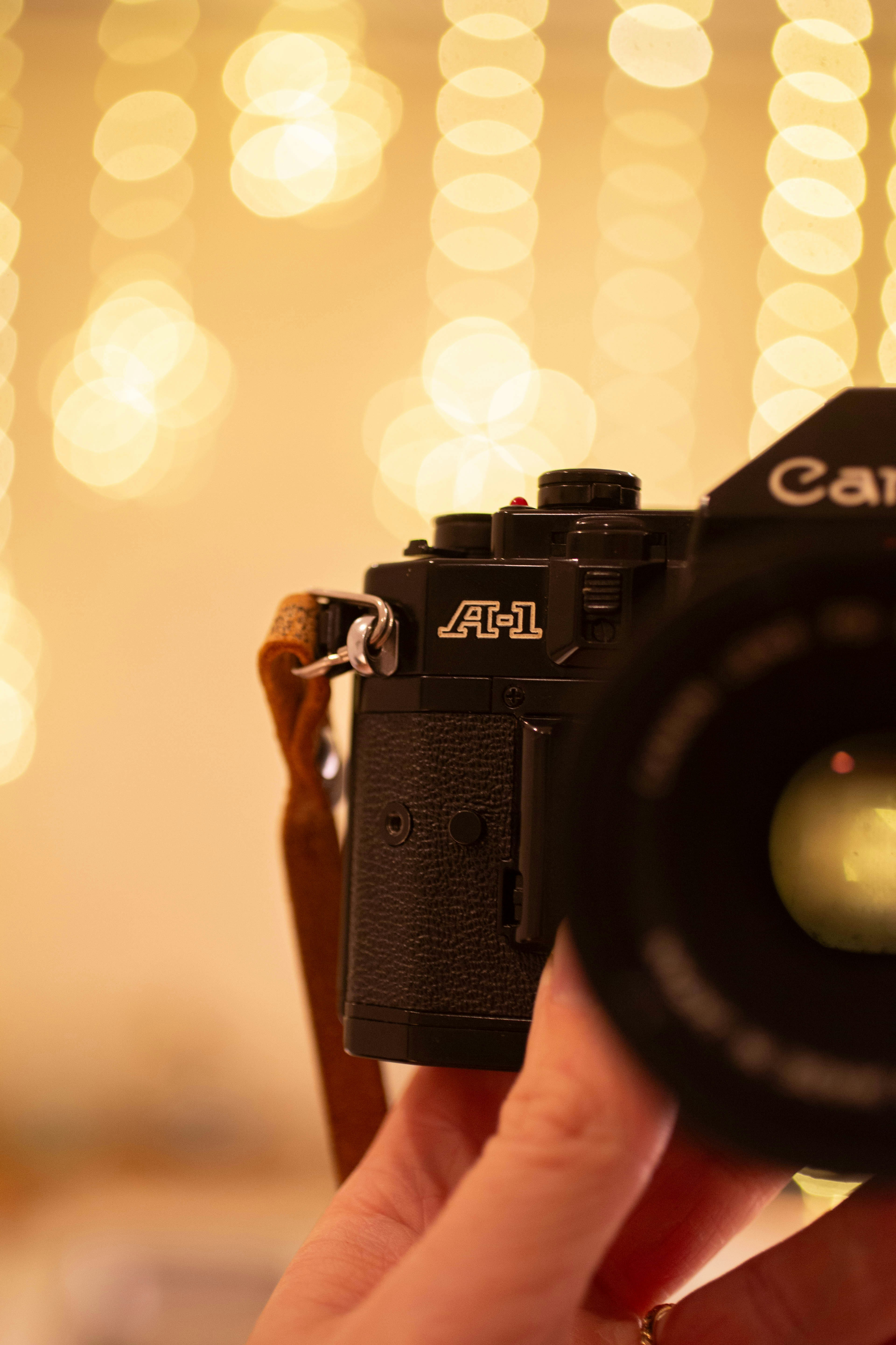 A vintage canon a-1 camera with a lens and strap