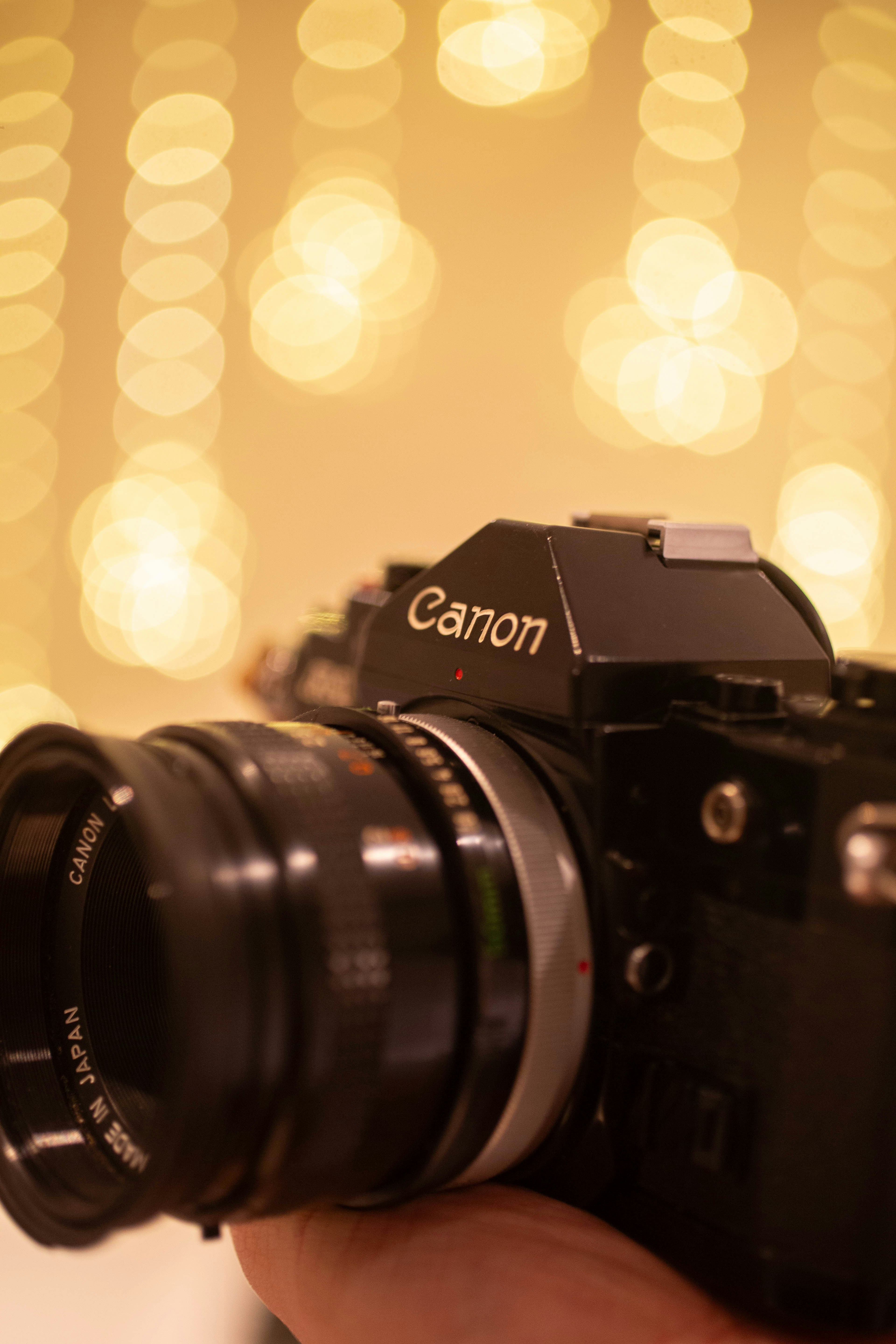 A vintage canon camera with a large lens.