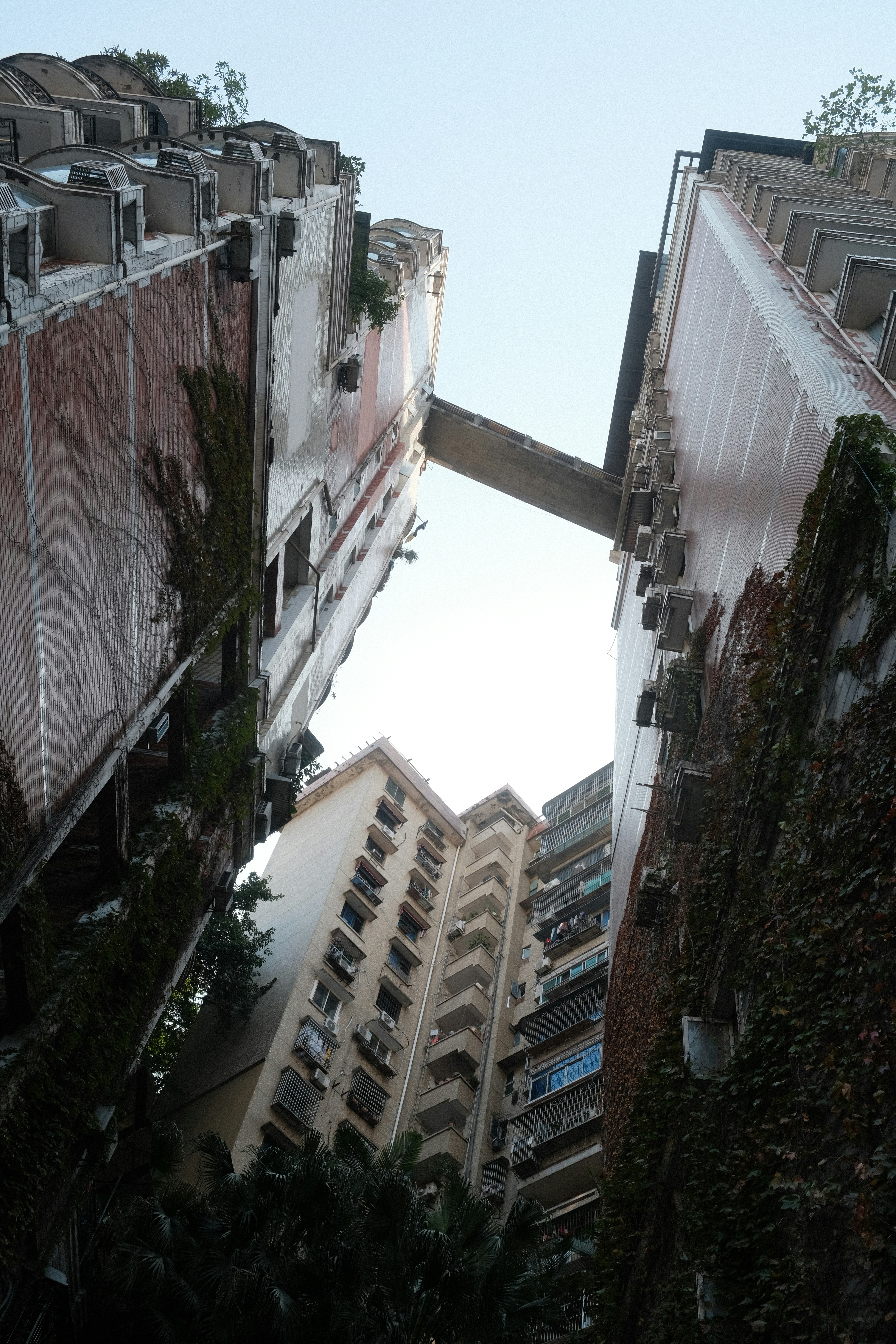 Two apartment buildings connected by a sky bridge.