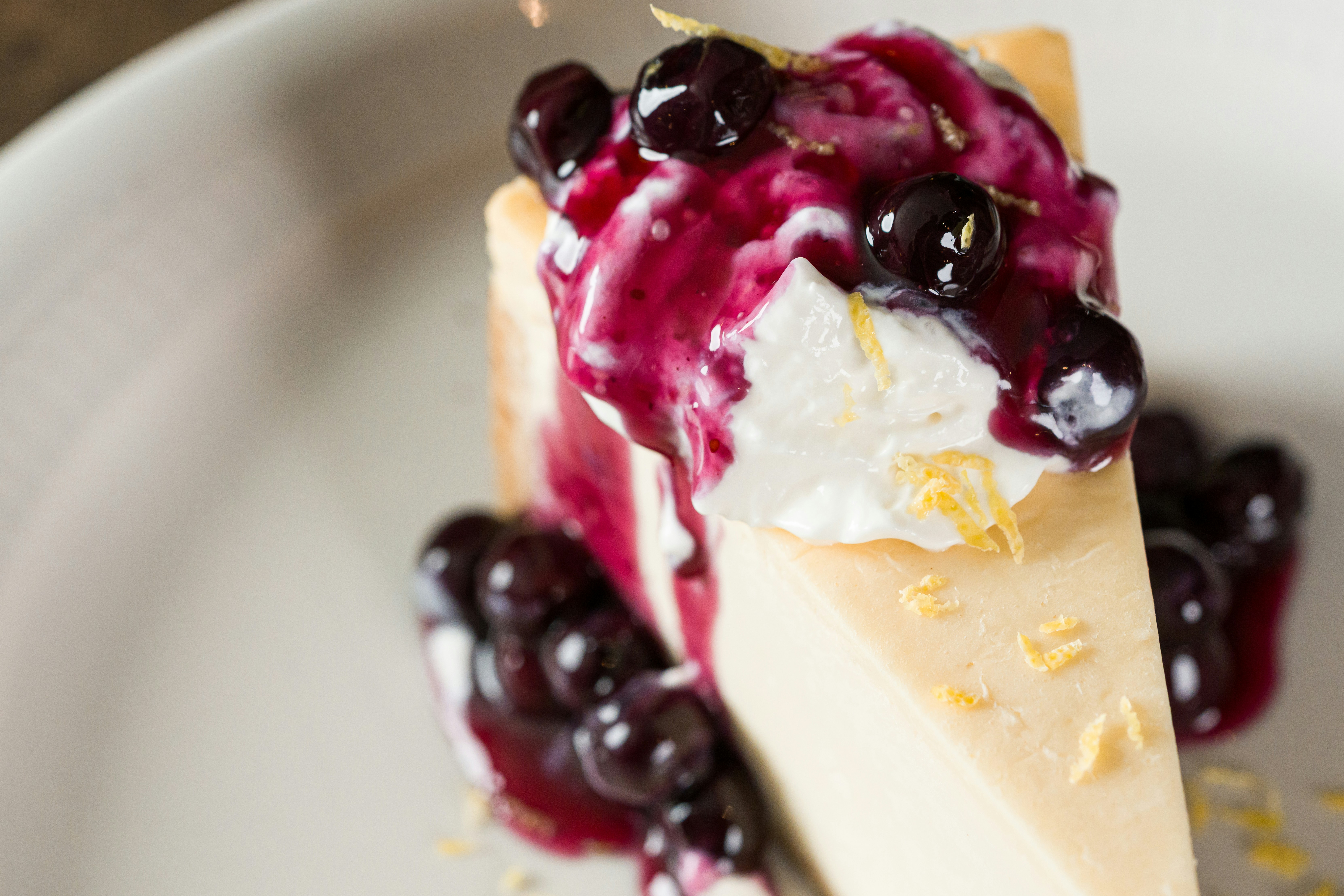 Slice of cheesecake with blueberries and whipped cream