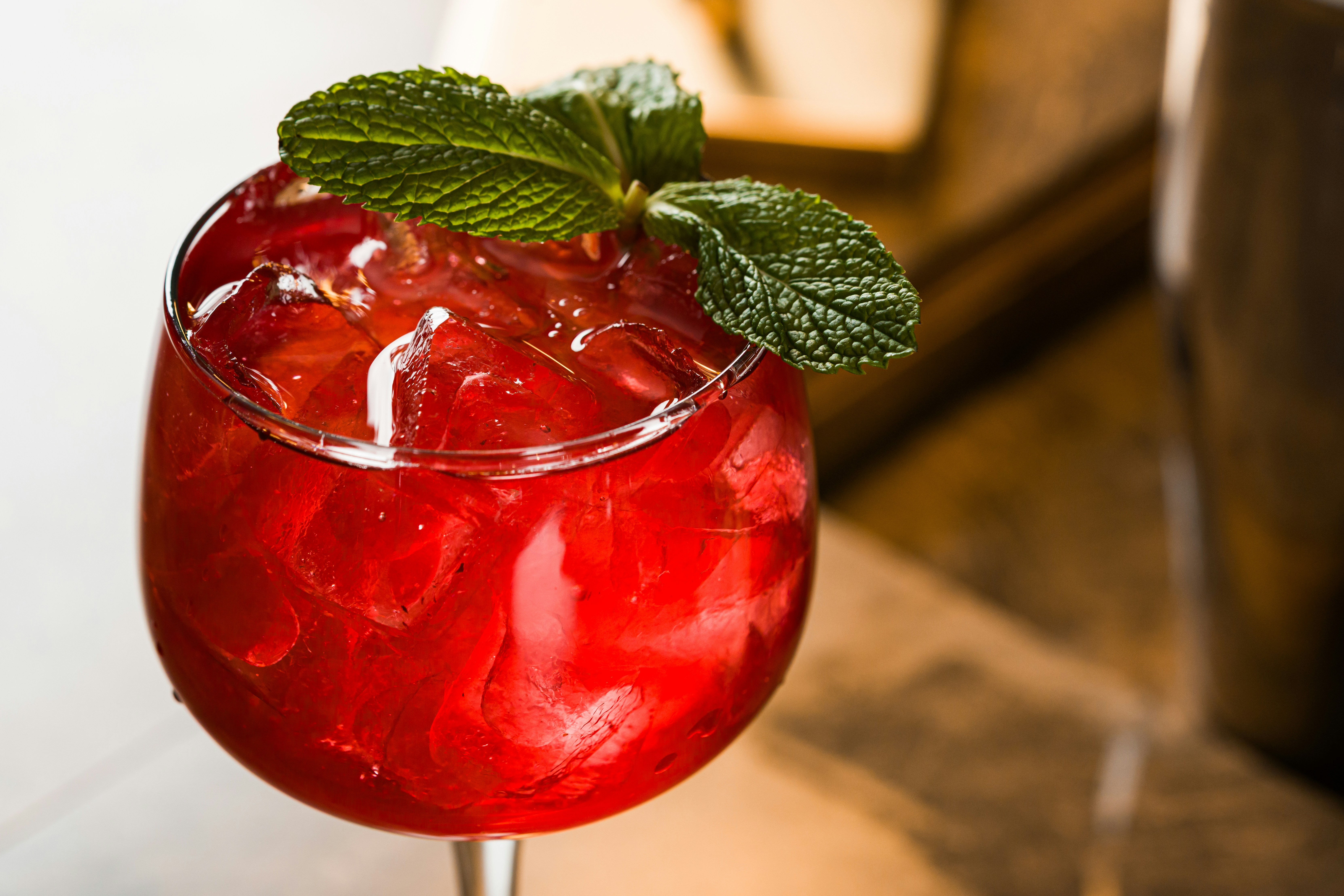 A refreshing red cocktail with mint garnish