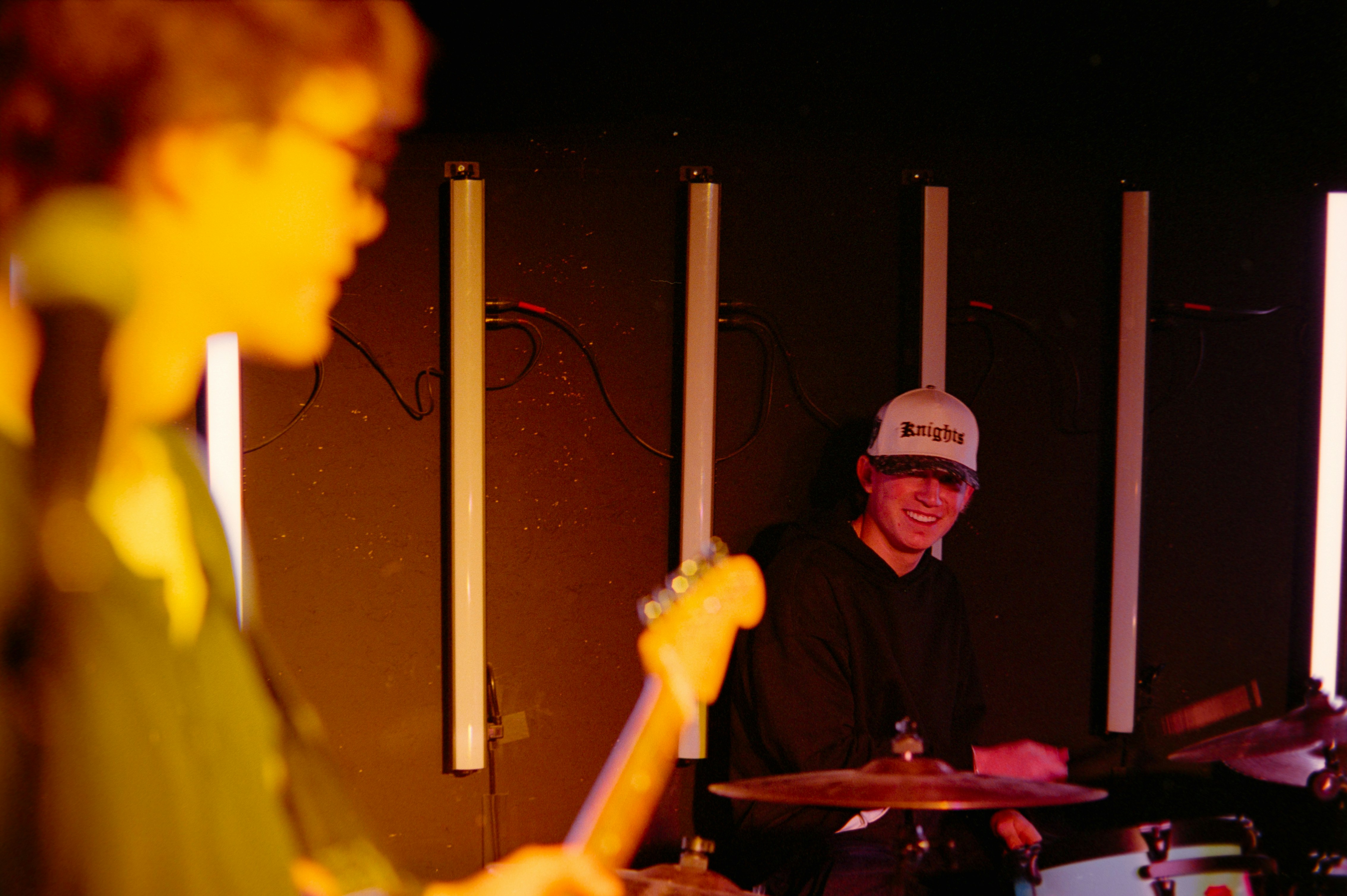 Musicians playing instruments on a stage at night.
