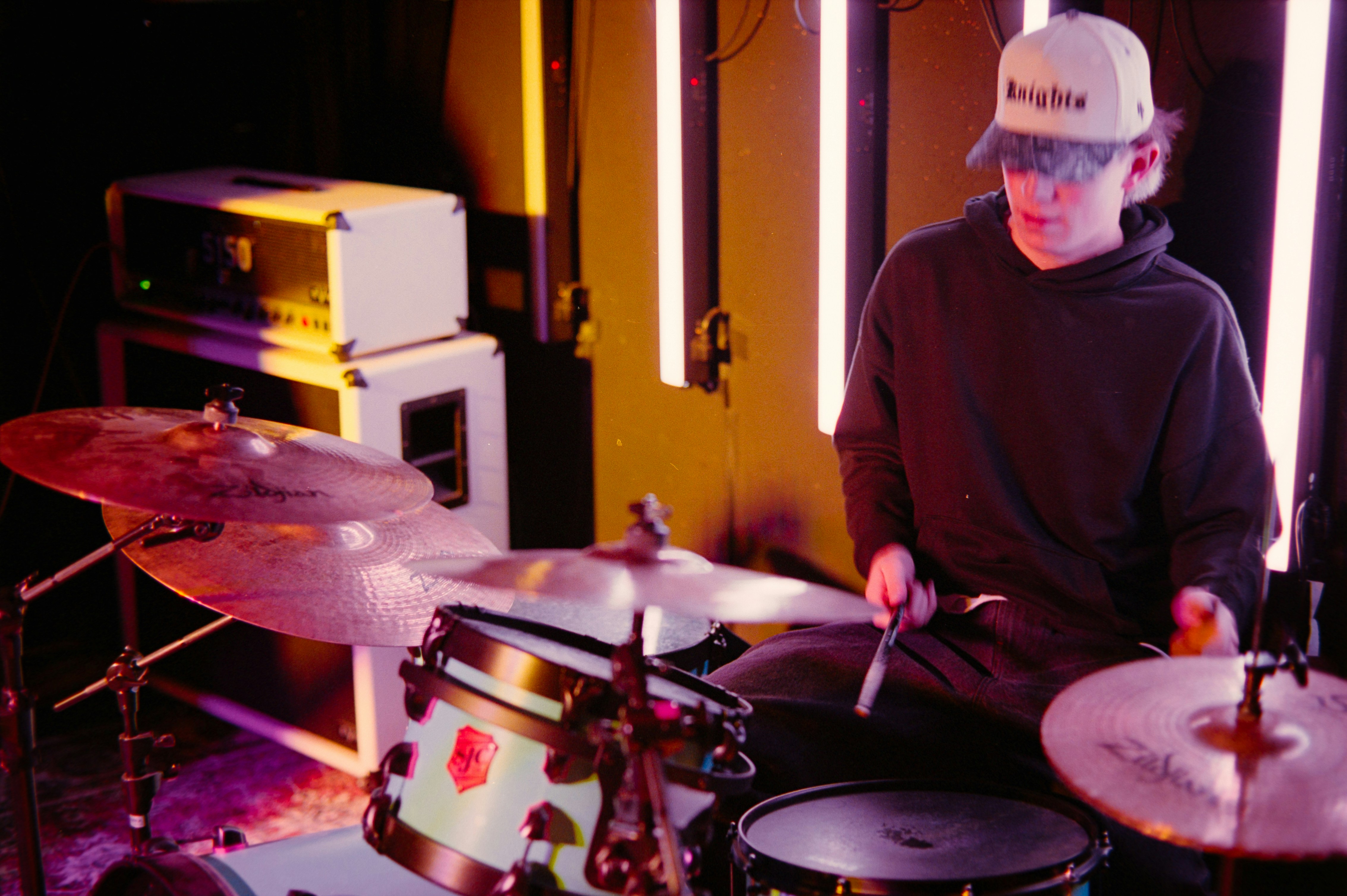 A person playing drums with colorful lights