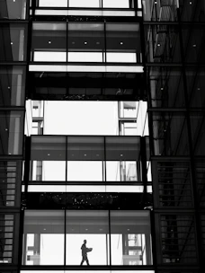 Silhouette of a person walking with a laptop.