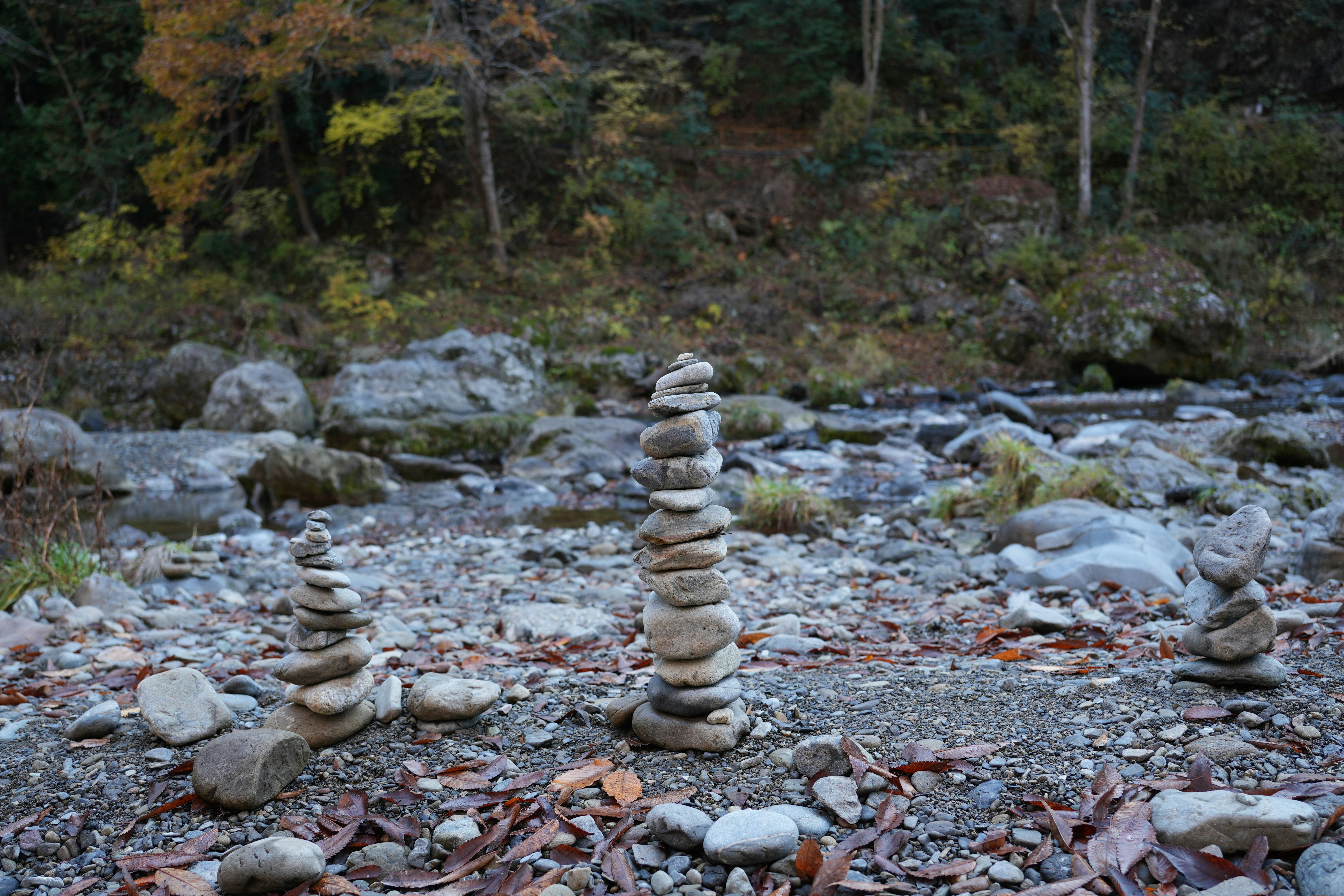 Stacked stones on rocky riverbank