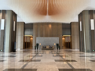 Modern lobby with marble floors and decorative ceiling