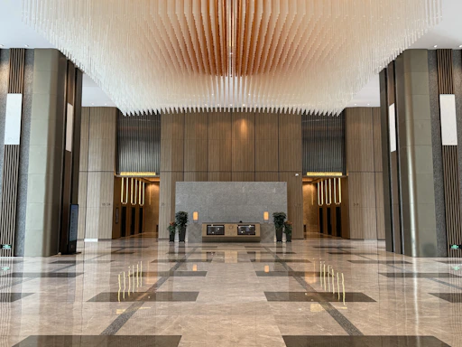 Modern lobby with marble floors and decorative ceiling