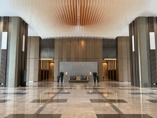 Modern lobby with marble floors and decorative ceiling