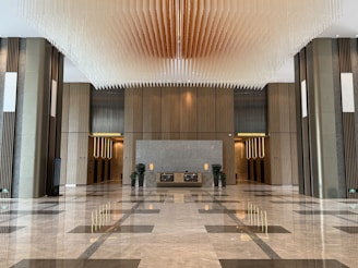 Modern lobby with marble floors and decorative ceiling