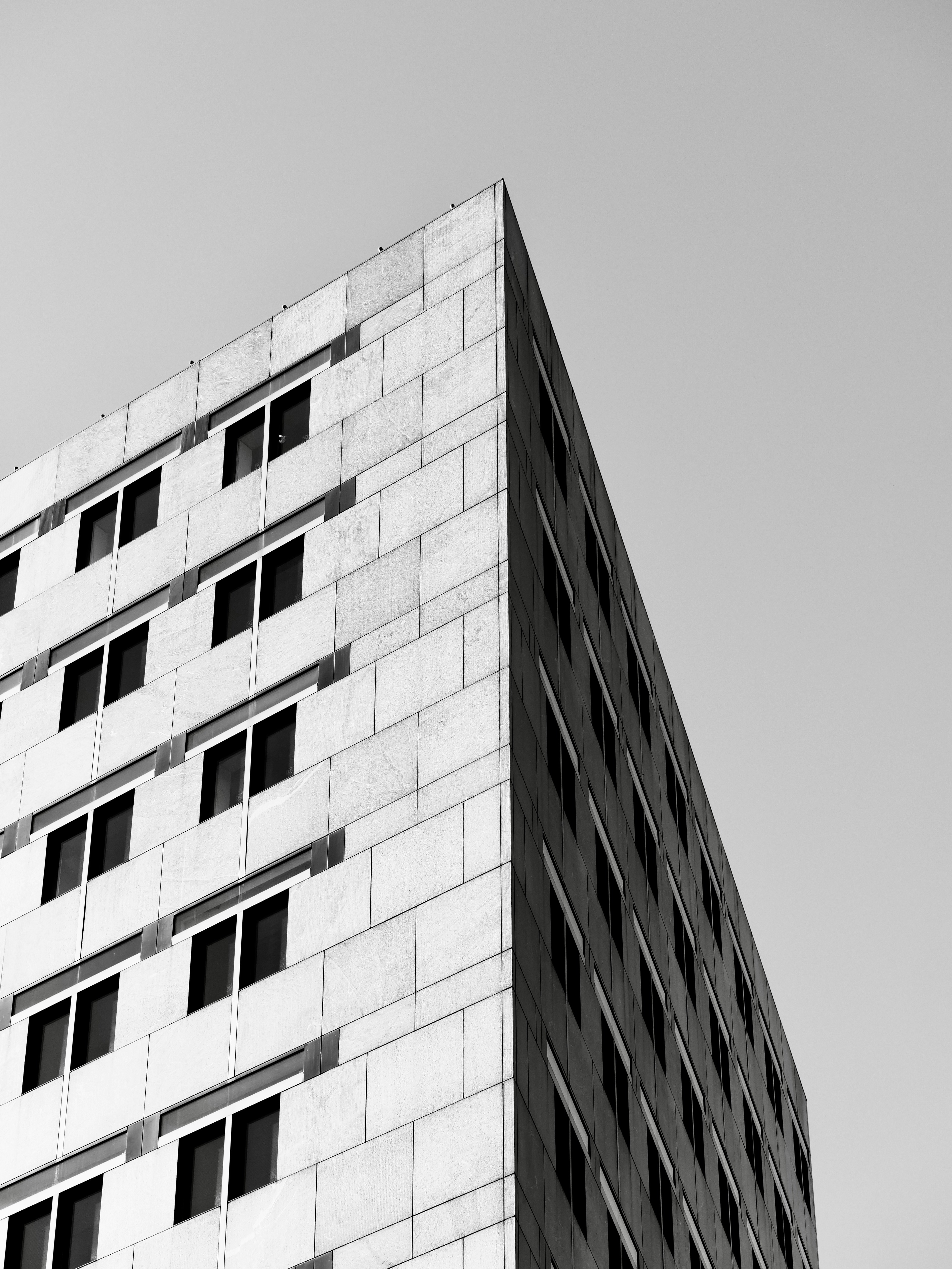 Modern building facade with repeating windows against sky