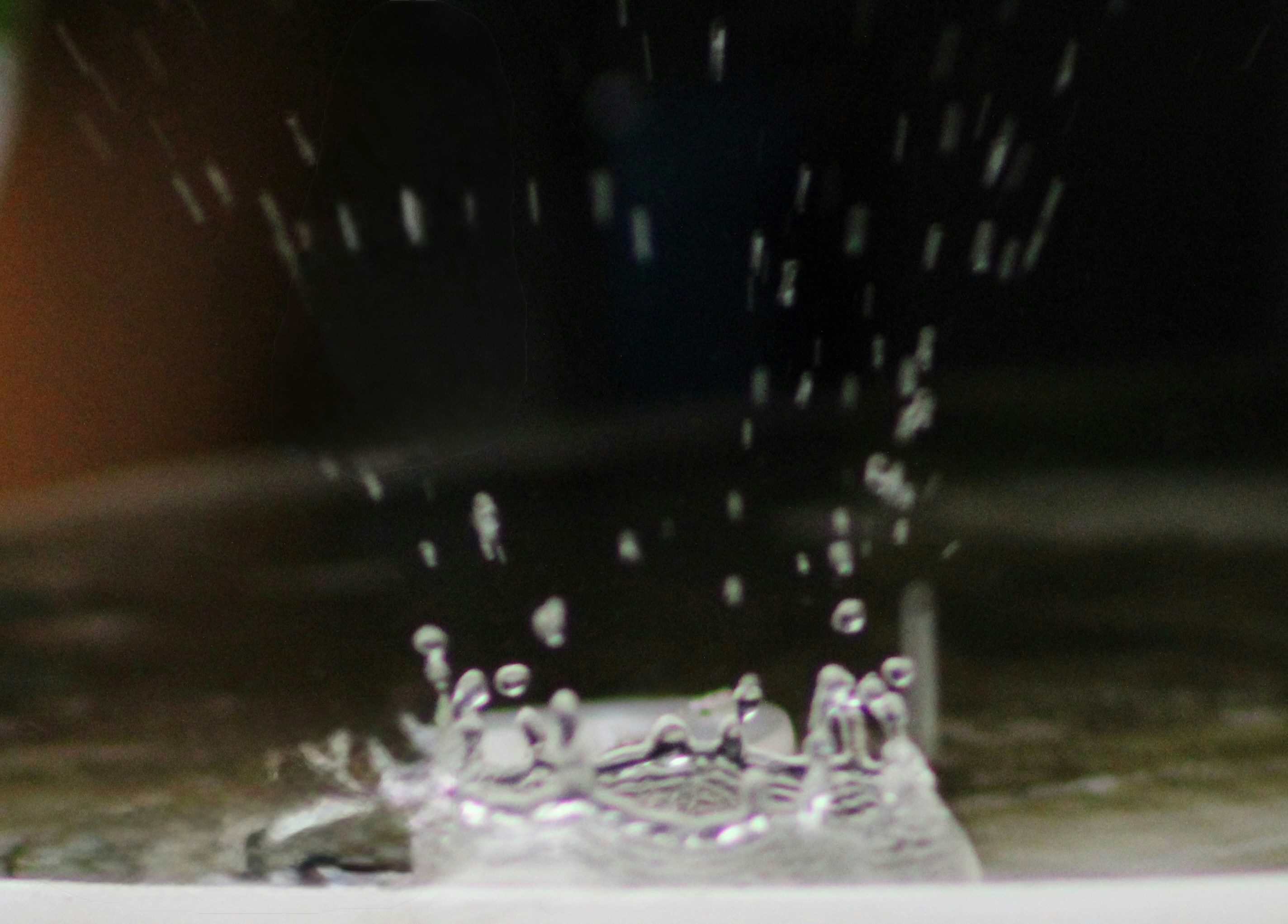 Water splashing on a surface with droplets flying.