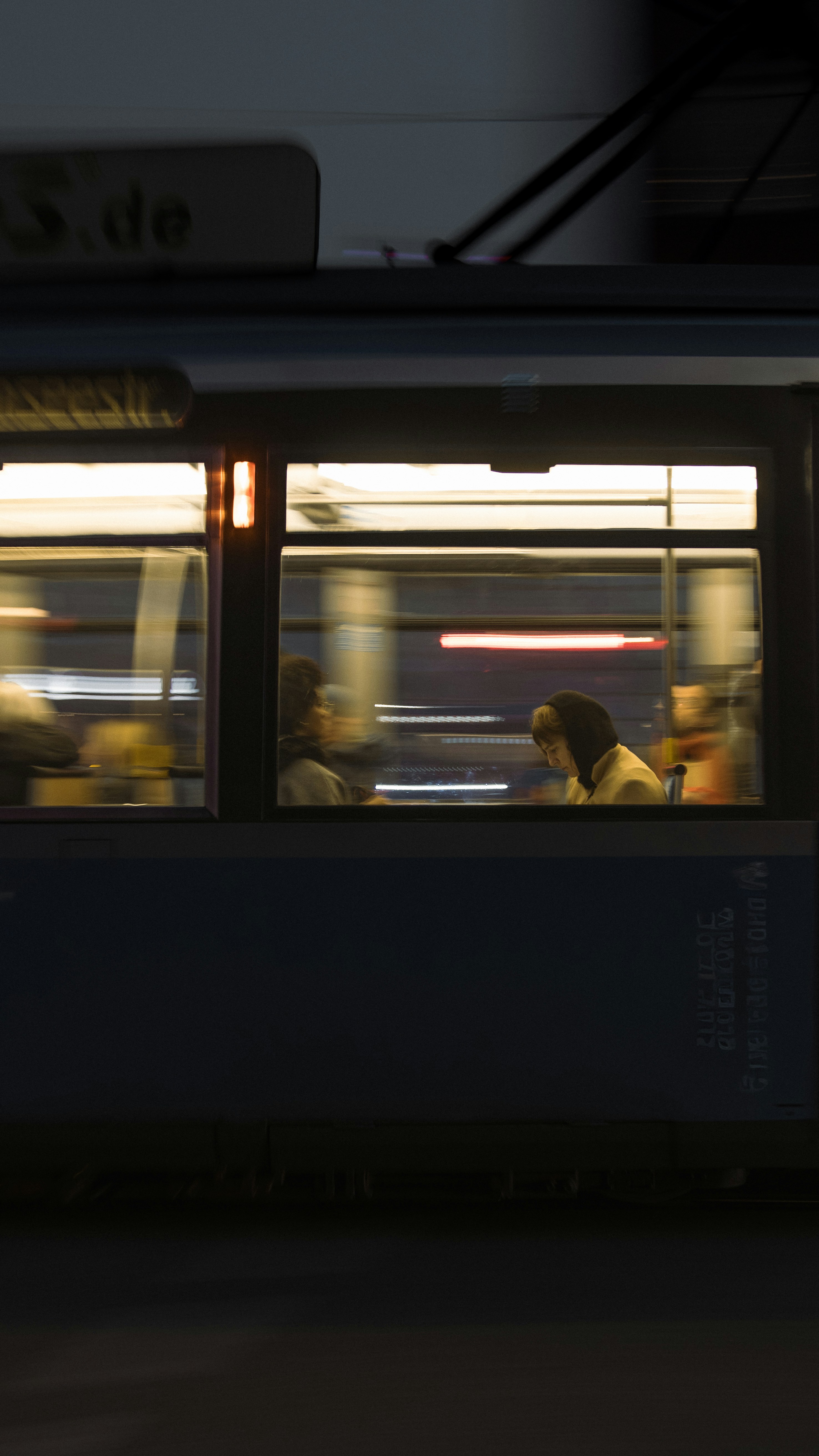 People inside a moving tram at night