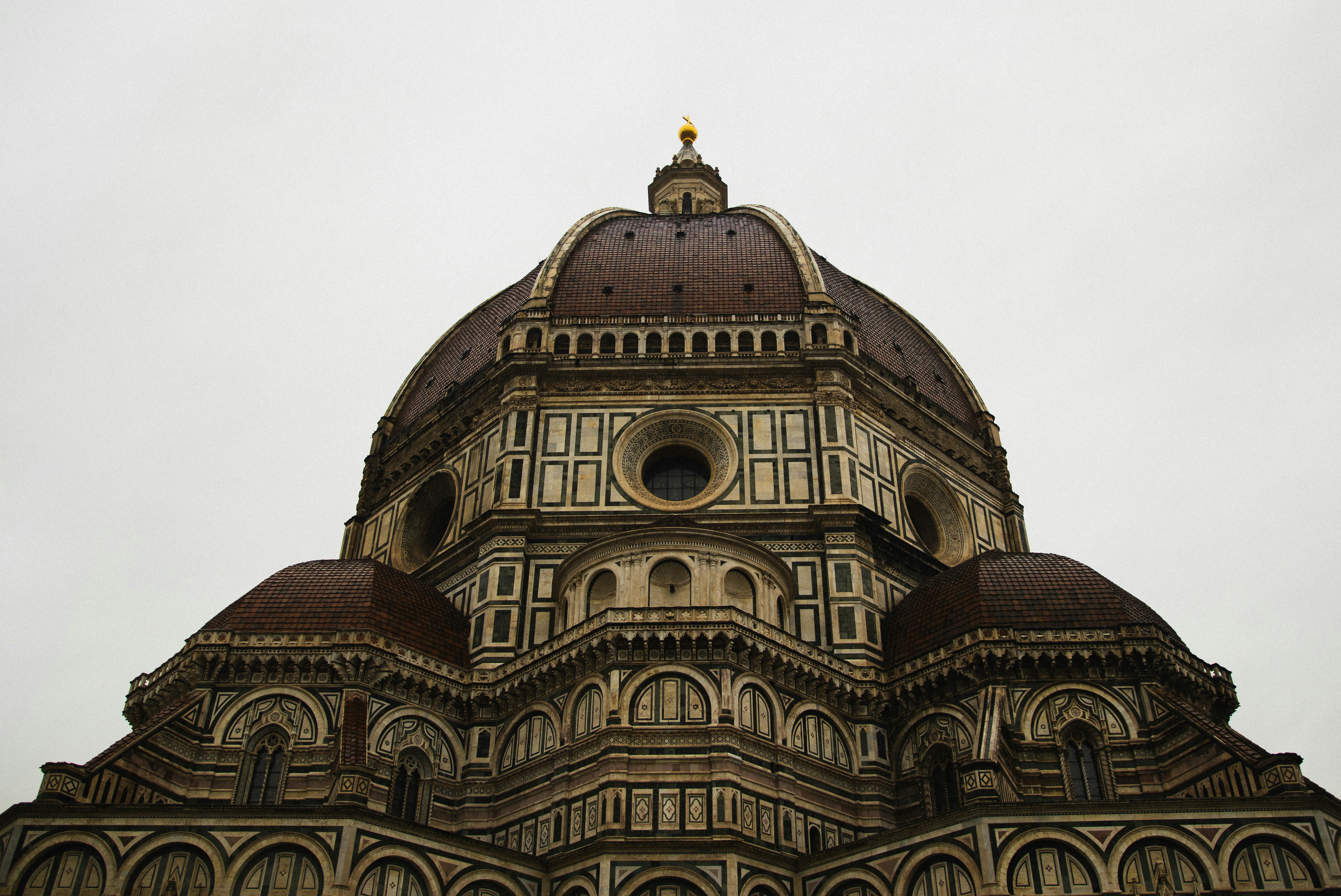 close-up of a large domed cathedral against a cloudy sky.