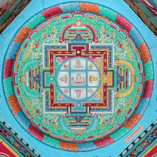 Intricate colorful mandala painted on a blue ceiling