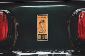 Shelby cobra emblem on a dark green car