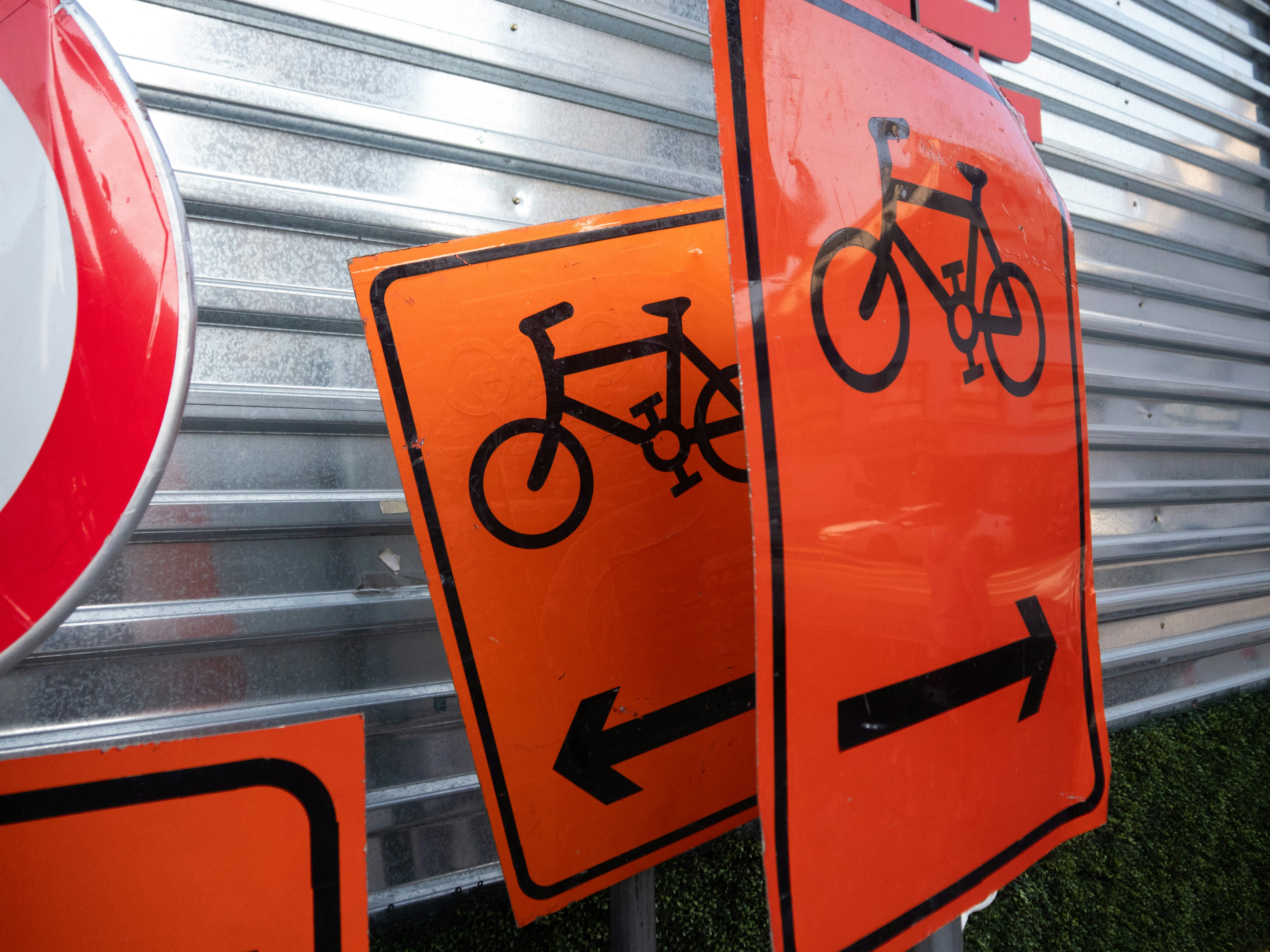 Orange bicycle signs with arrows