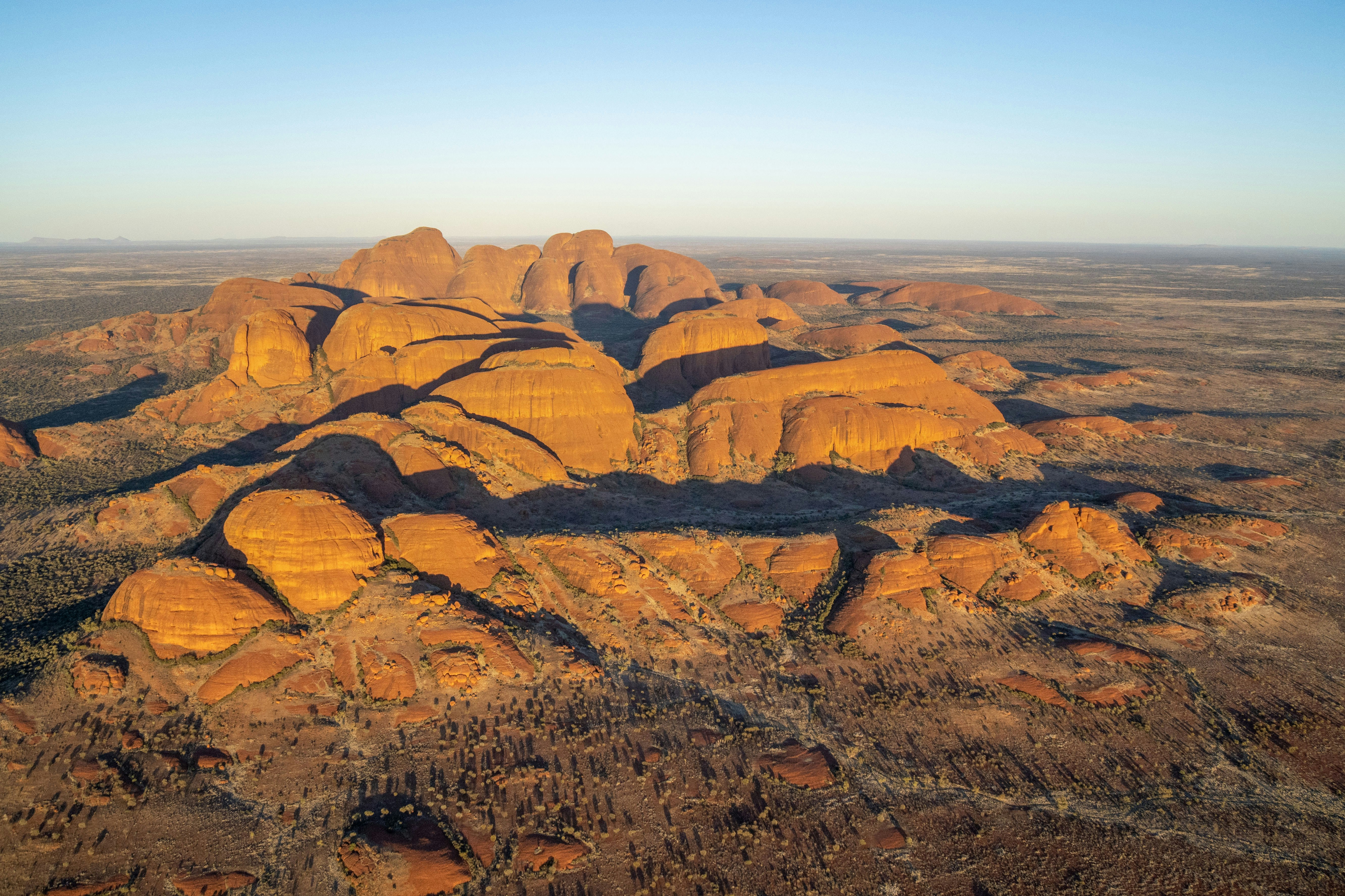 Kata tjuta rock formations at sunrise with long shadows