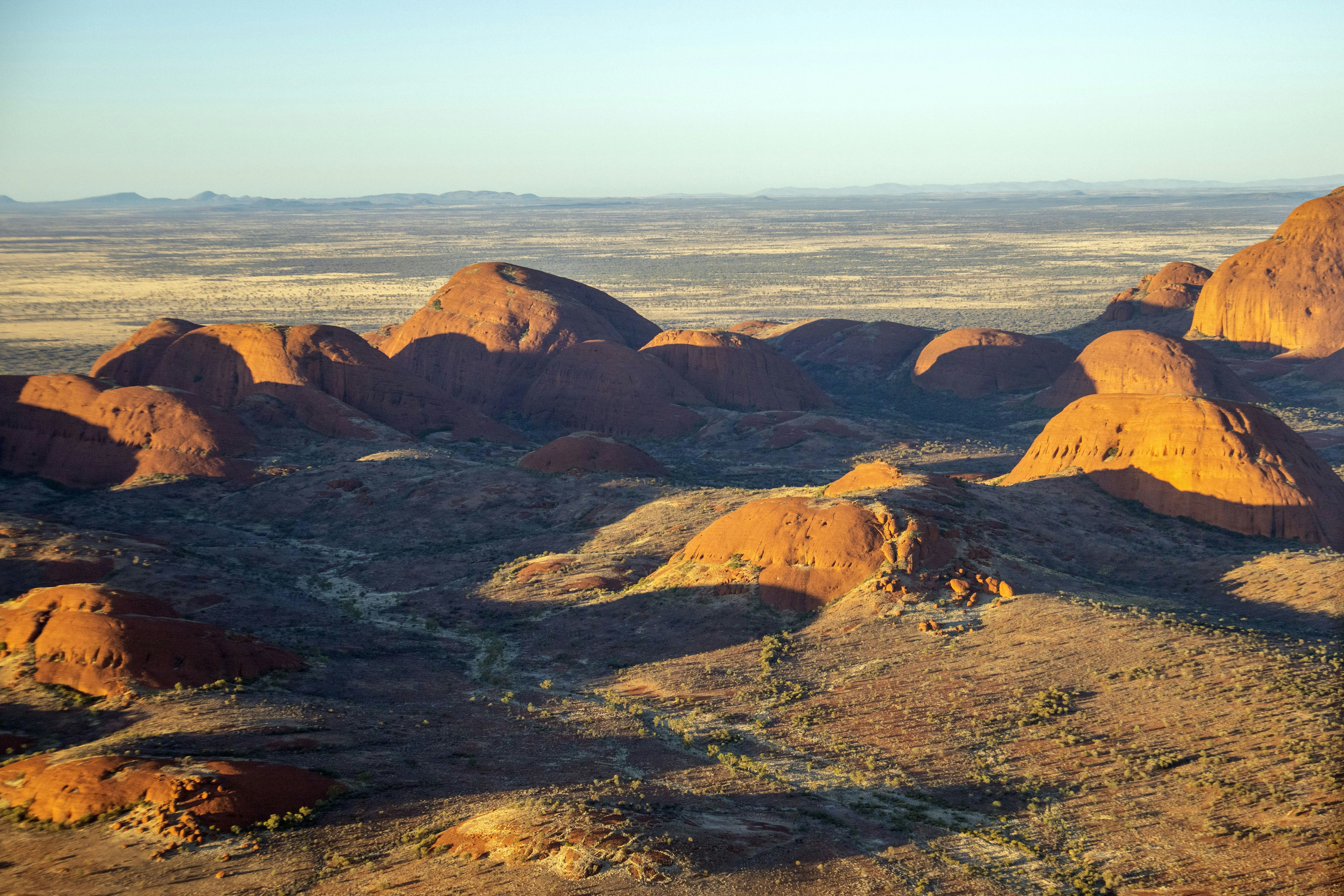 Desert landscape with rounded rock formations at sunset