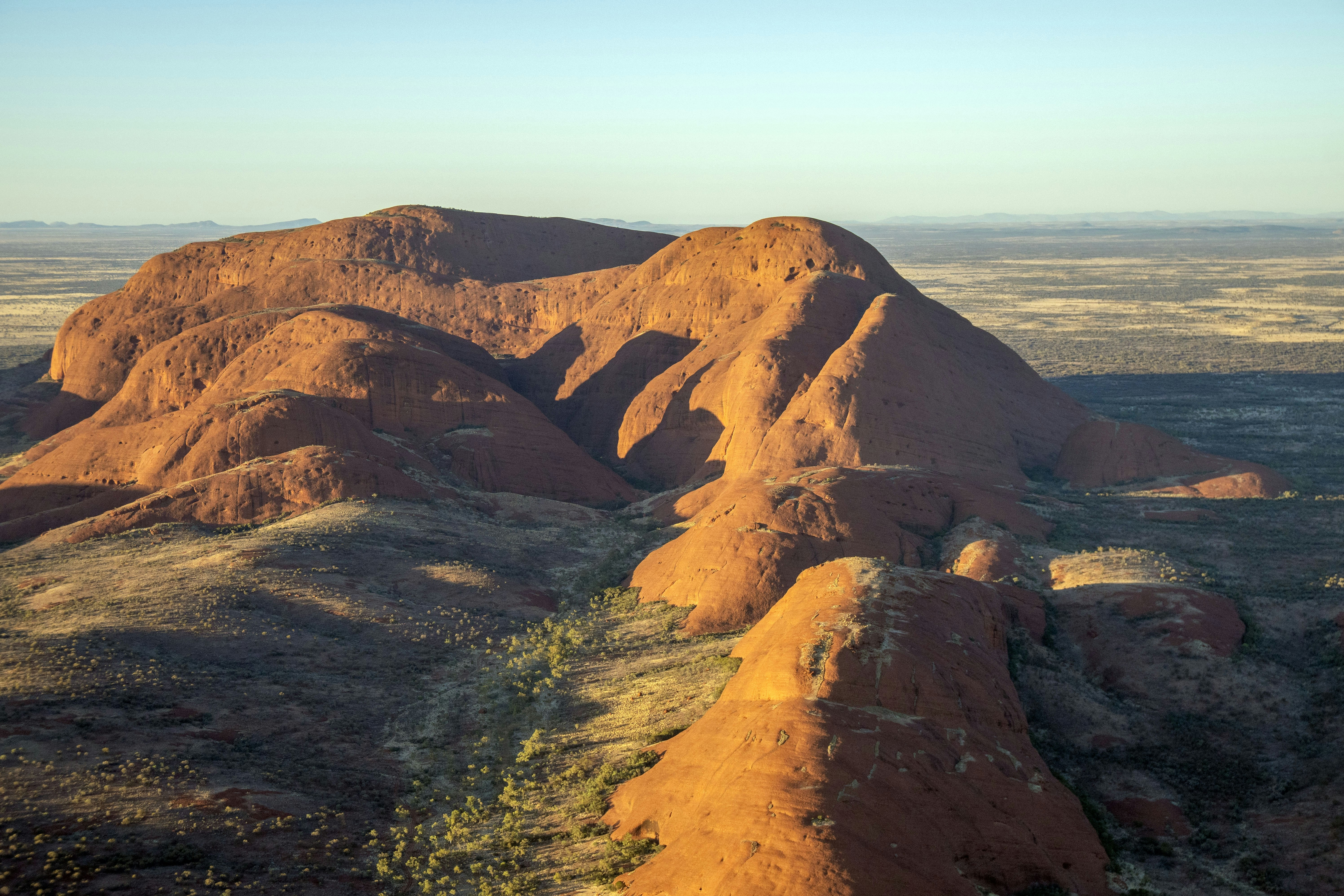 Massive sandstone rock formation in a desert landscape.