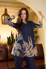 A woman in a blue floral tunic and pants