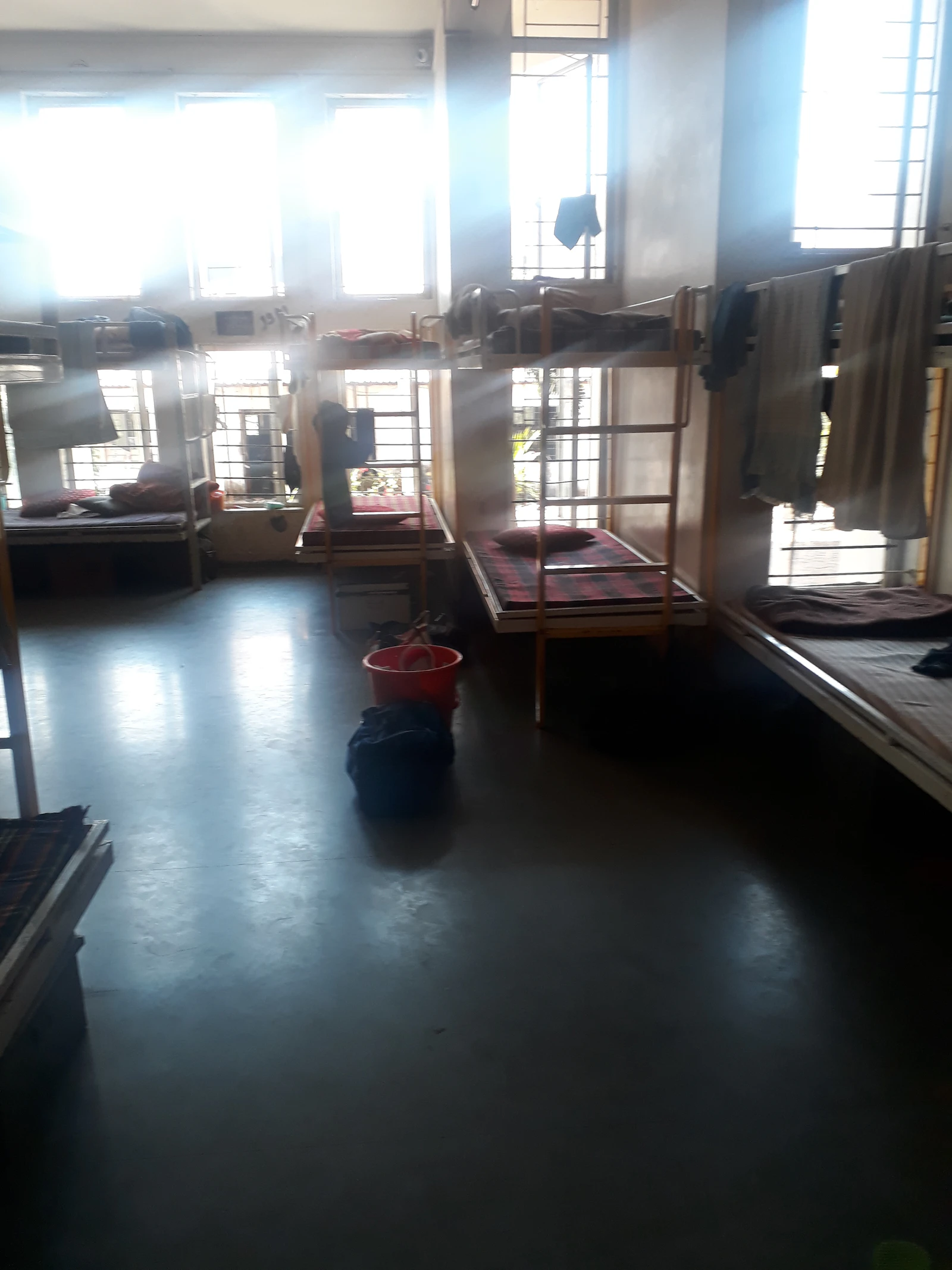 Dormitory beds with morning sunlight through the window