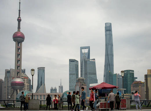 People gather near oriental pearl tower and skyscrapers