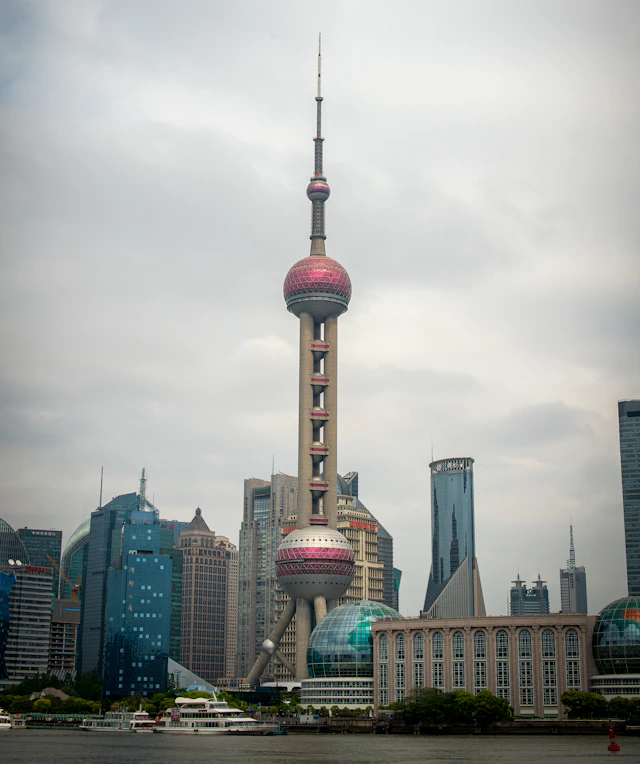 Shanghai Oriental Pearl Tower, its pink spheres and waterfront buildings beside the Huangpu River