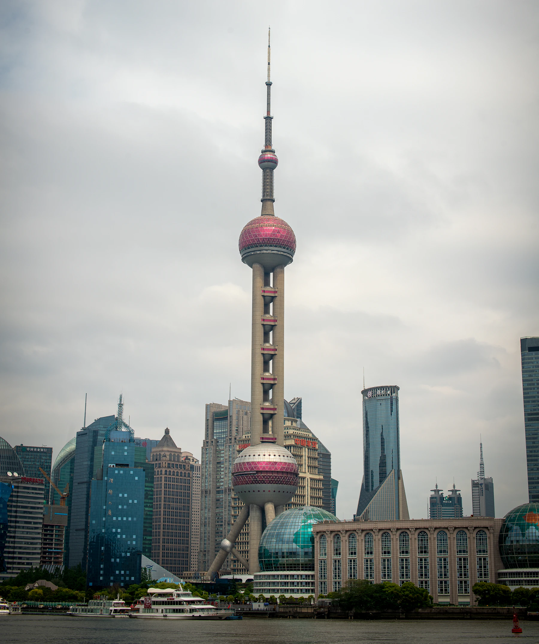 Shanghai Oriental Pearl Tower, its pink spheres and waterfront buildings beside the Huangpu River