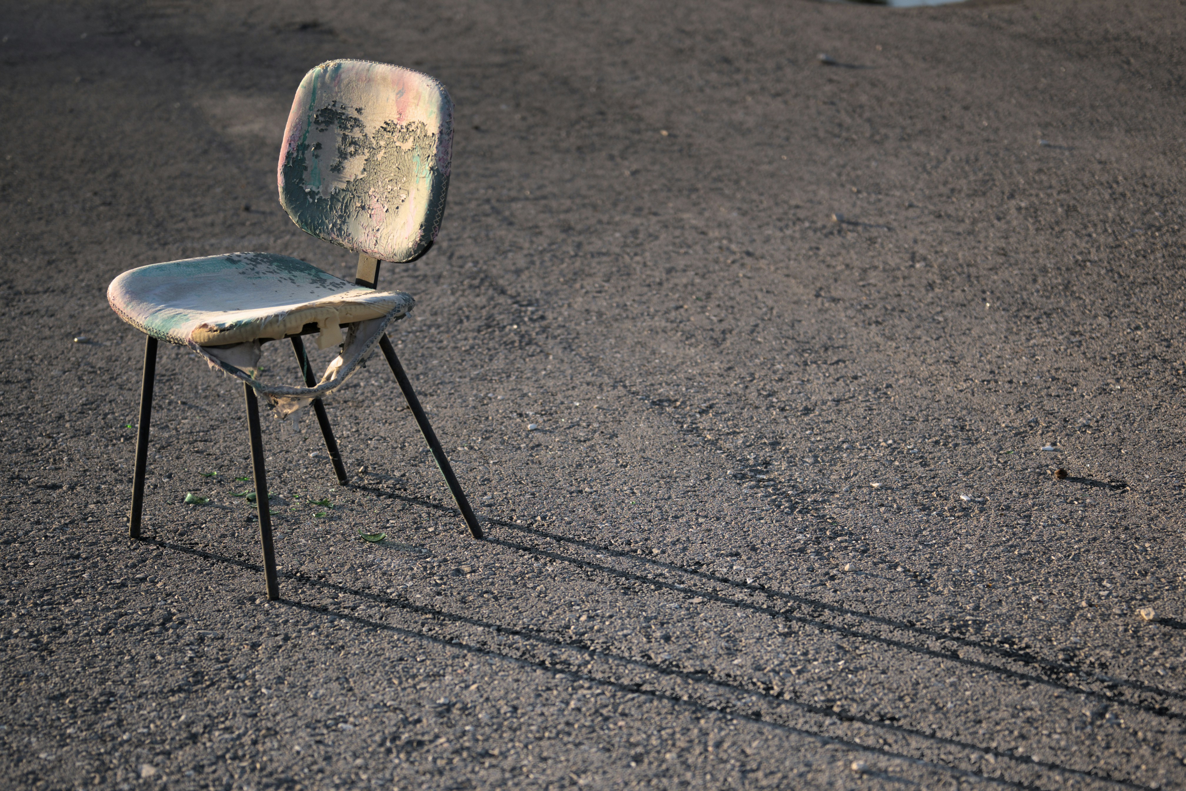 An old chair casts a long shadow on the ground photo – Free Chair Image ...