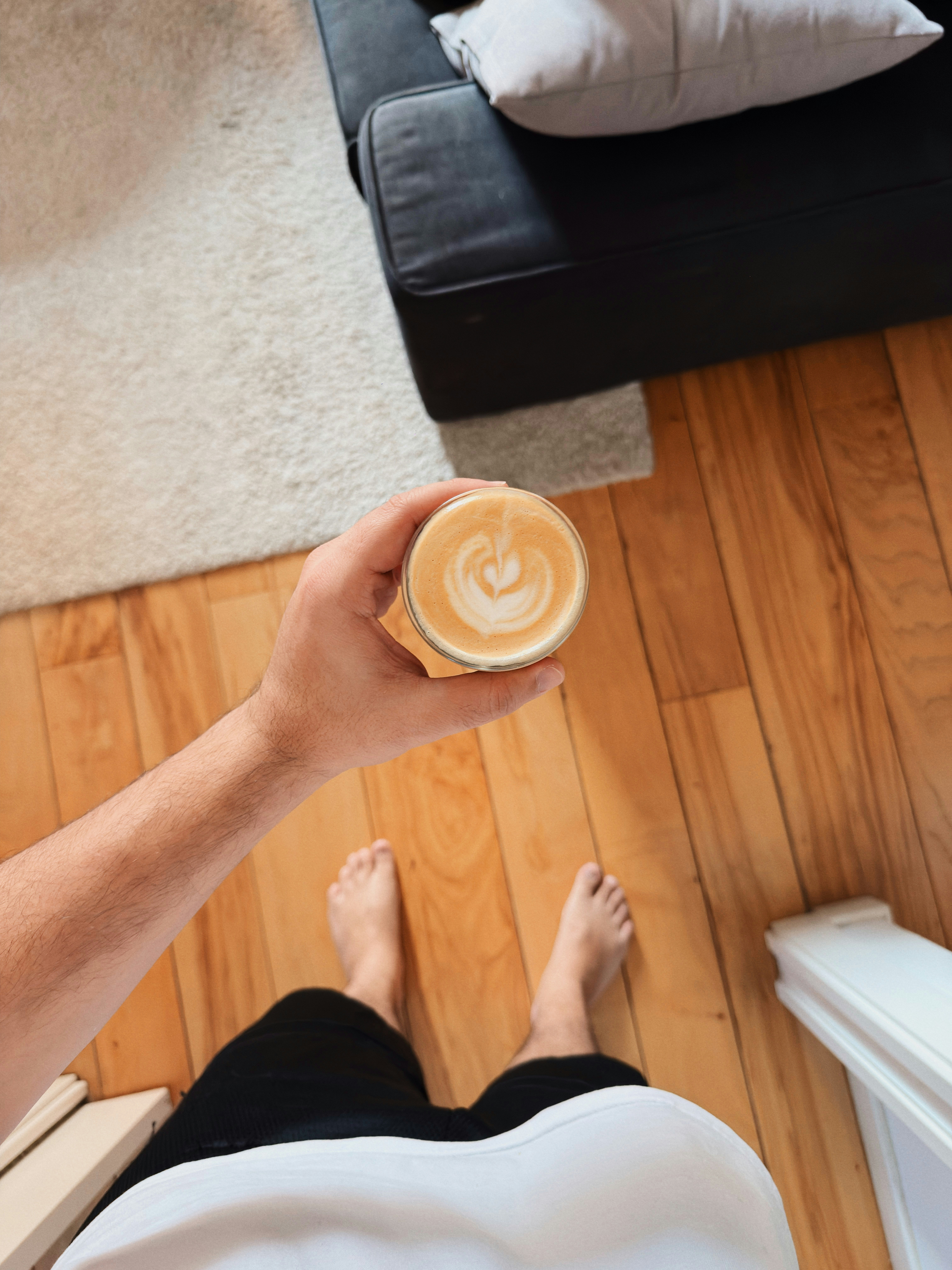Hand holding a latte with heart art