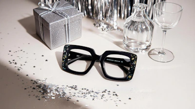 Black framed glasses with festive decorations on a table.