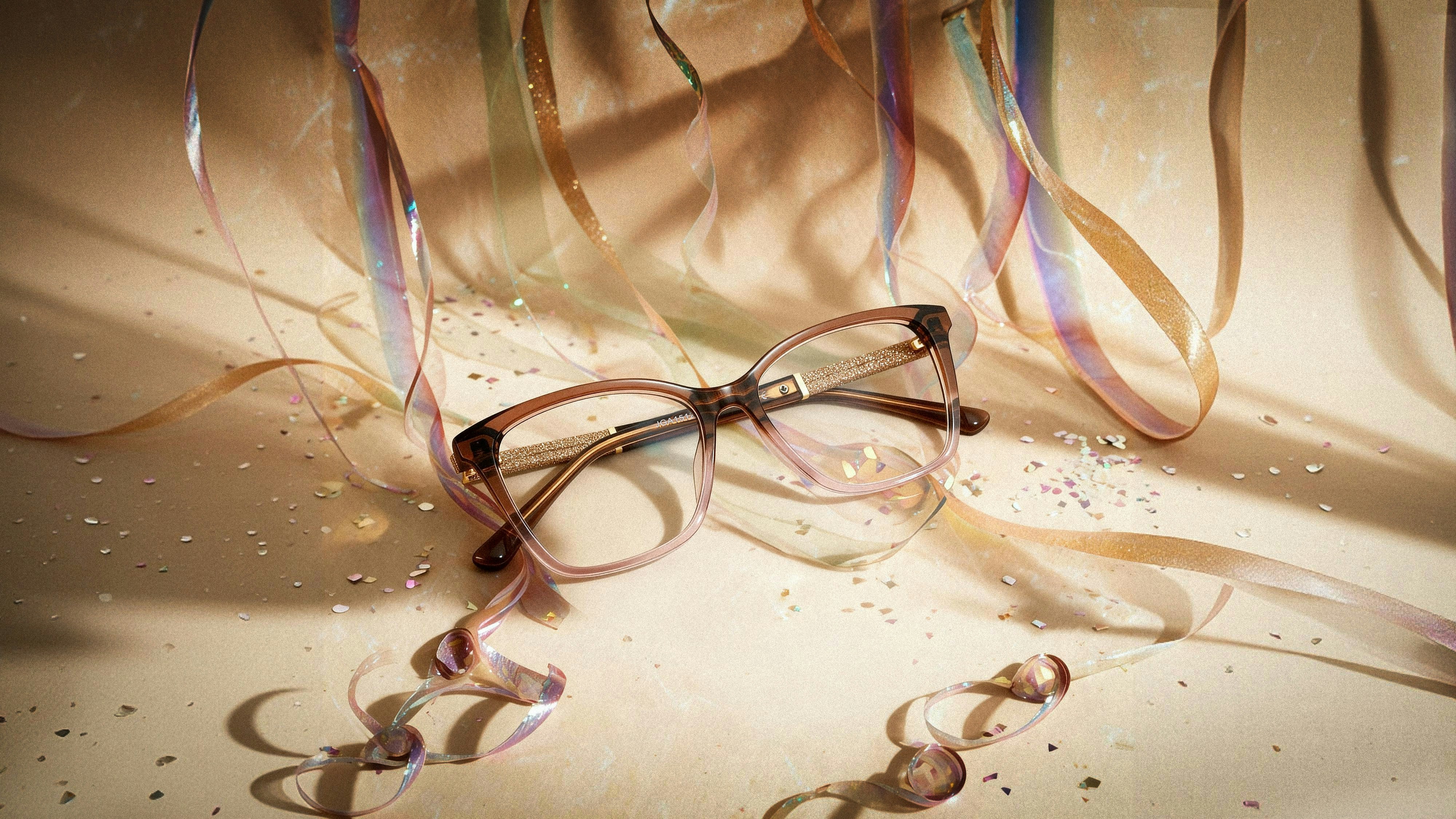 Eyeglasses resting amidst streamers and confetti