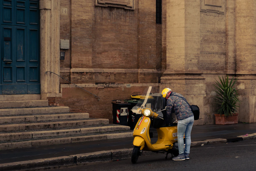 Yellow scooter beside a city building