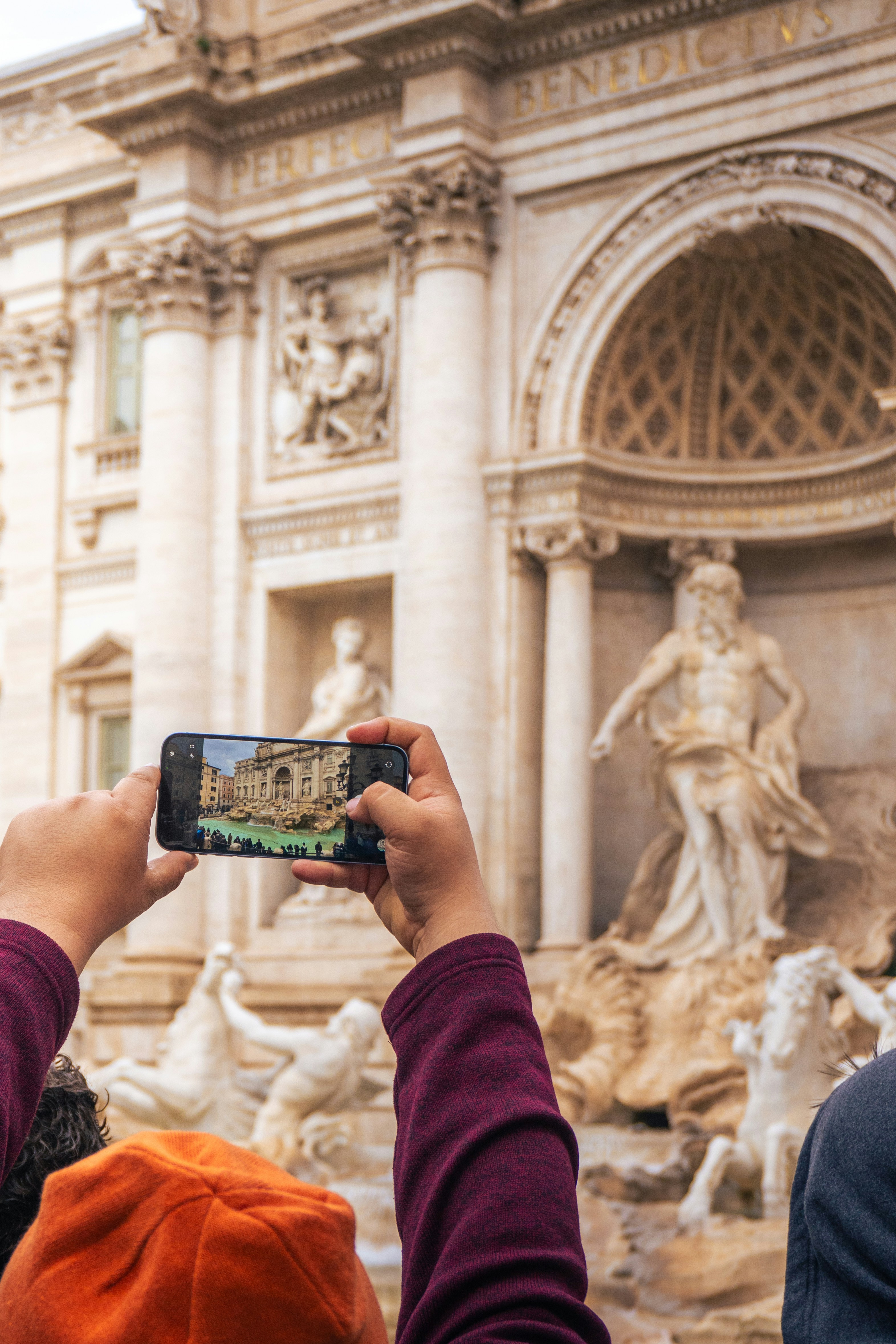 Person taking a picture of a famous fountain