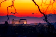 The acropolis of athens at sunset with vibrant sky.