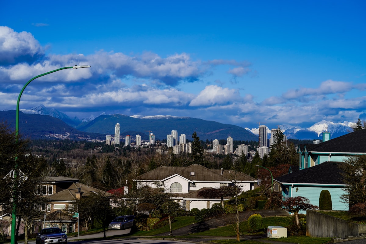 Suburban homes with distant city skyline and mountains
