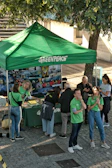 People gathered around a green greenpeace information tent.