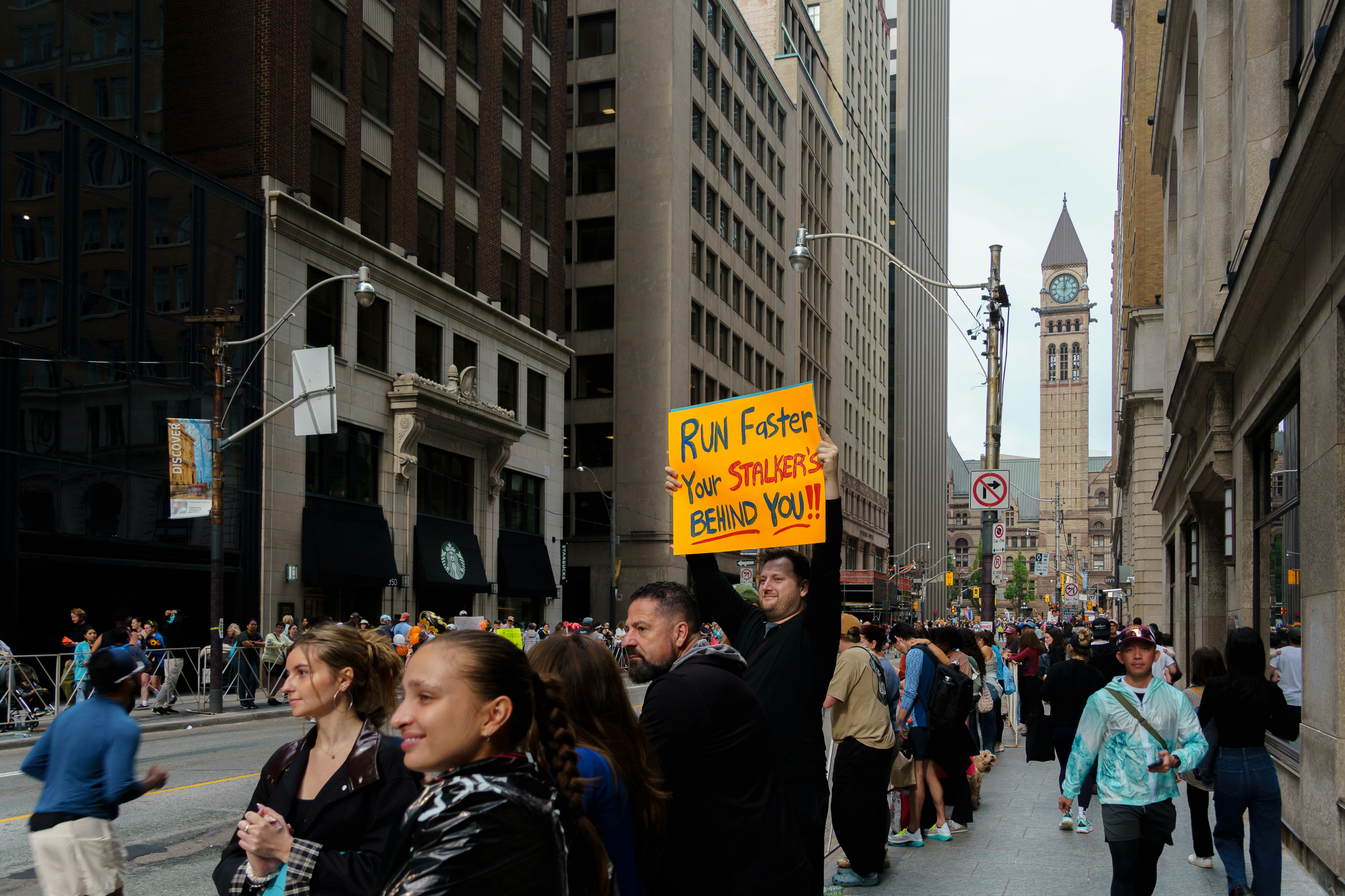 Crowd on a city street holding protest signs