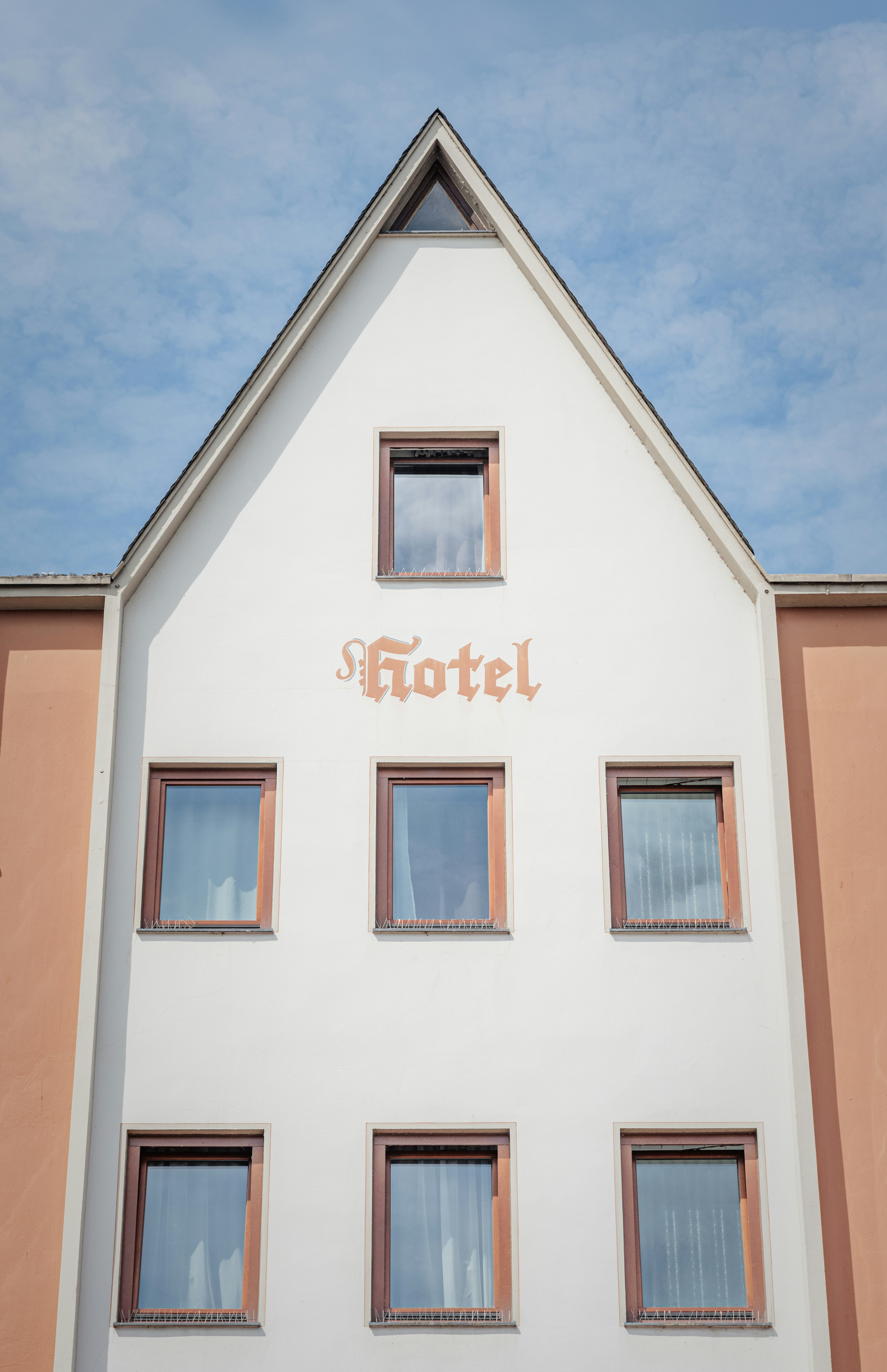 Hotel sign on a building with many windows