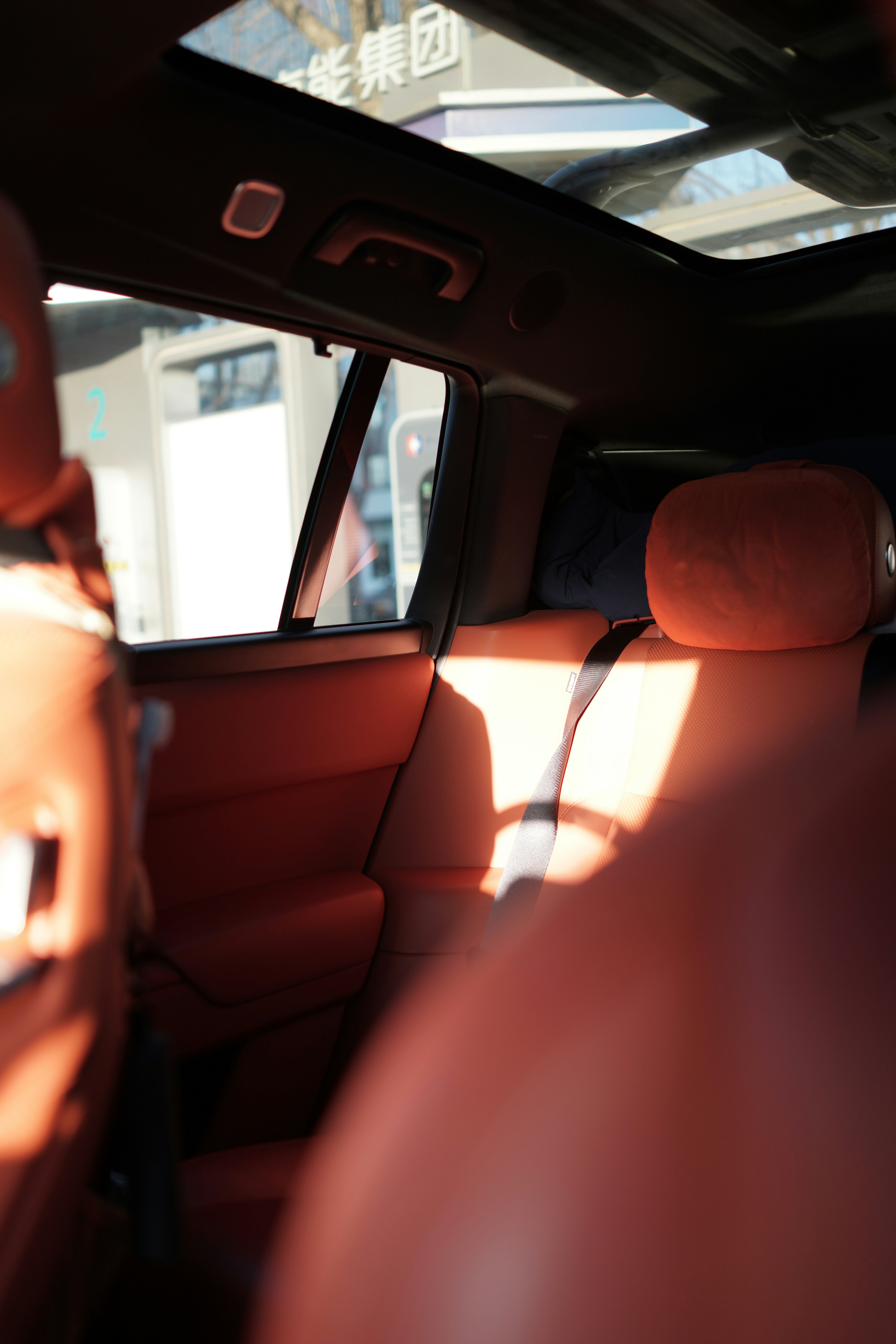 Interior view of a car with red leather seats.
