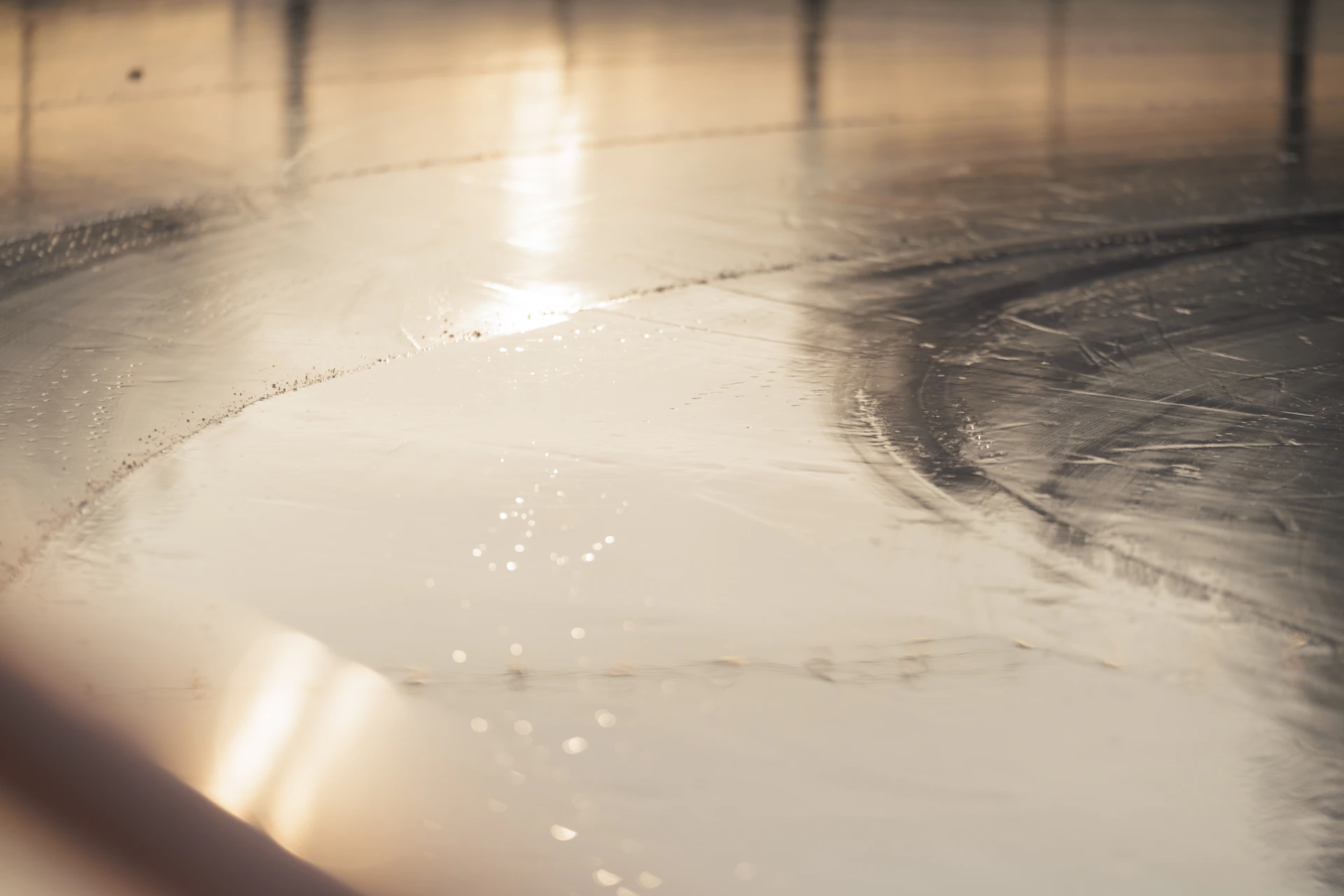 Sunlight reflecting on a wet, shiny floor