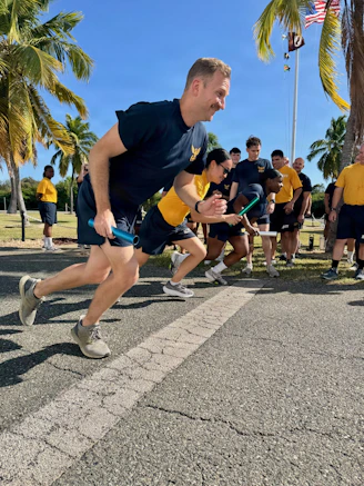 Sailors participate in a relay race outdoors