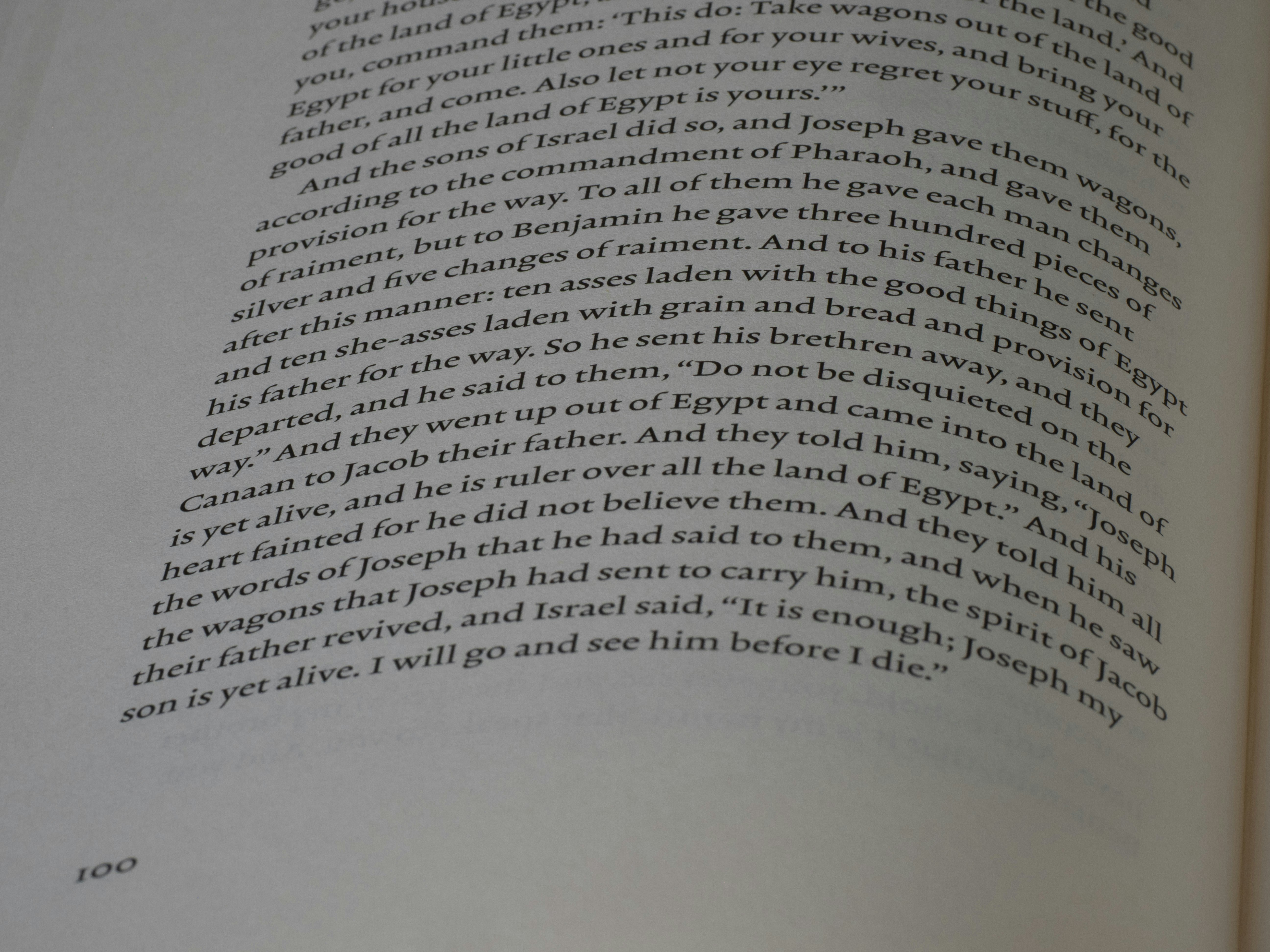 Close-up of text from a book with curved lines.