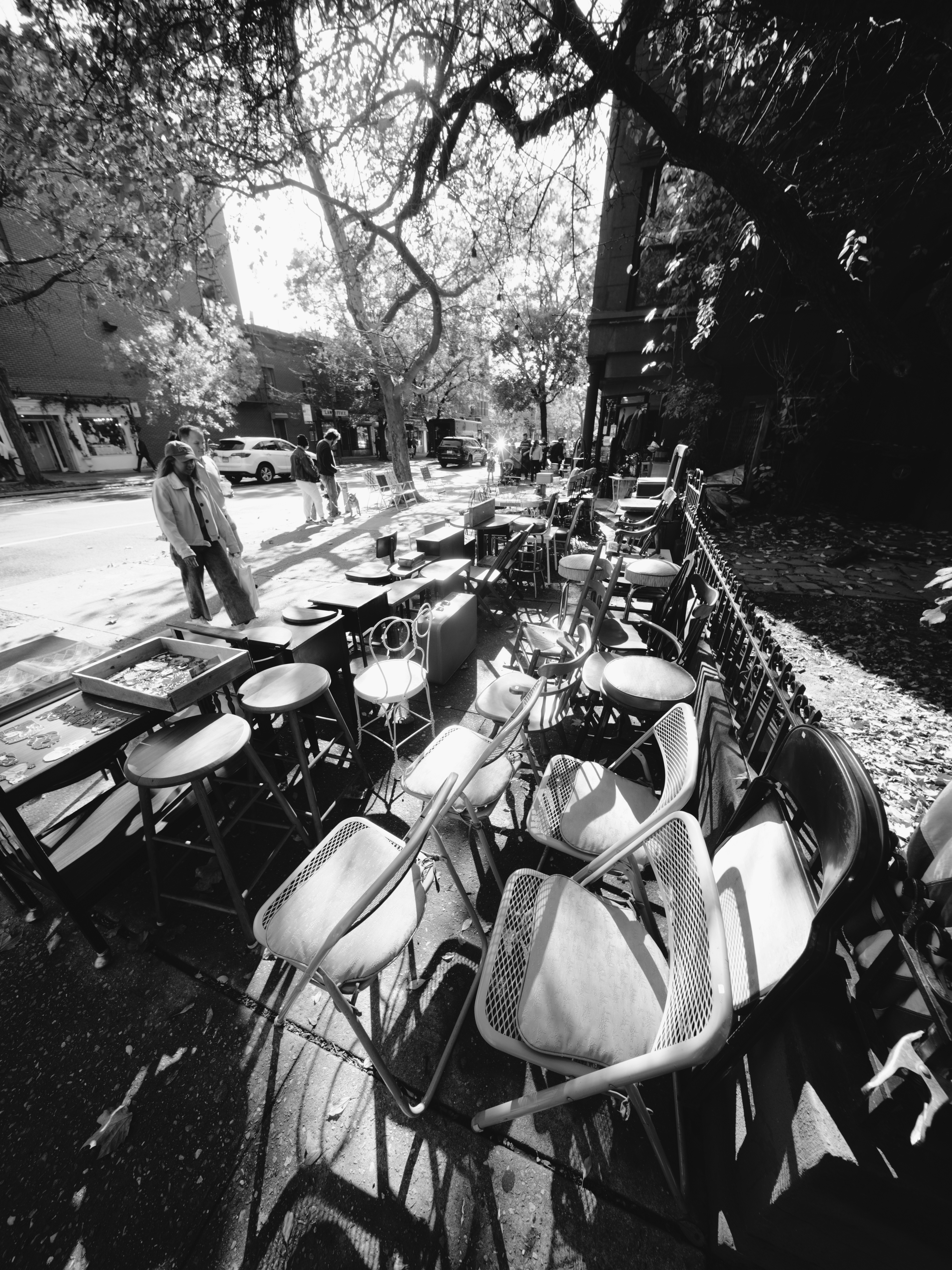 Chairs and tables arranged on a sidewalk
